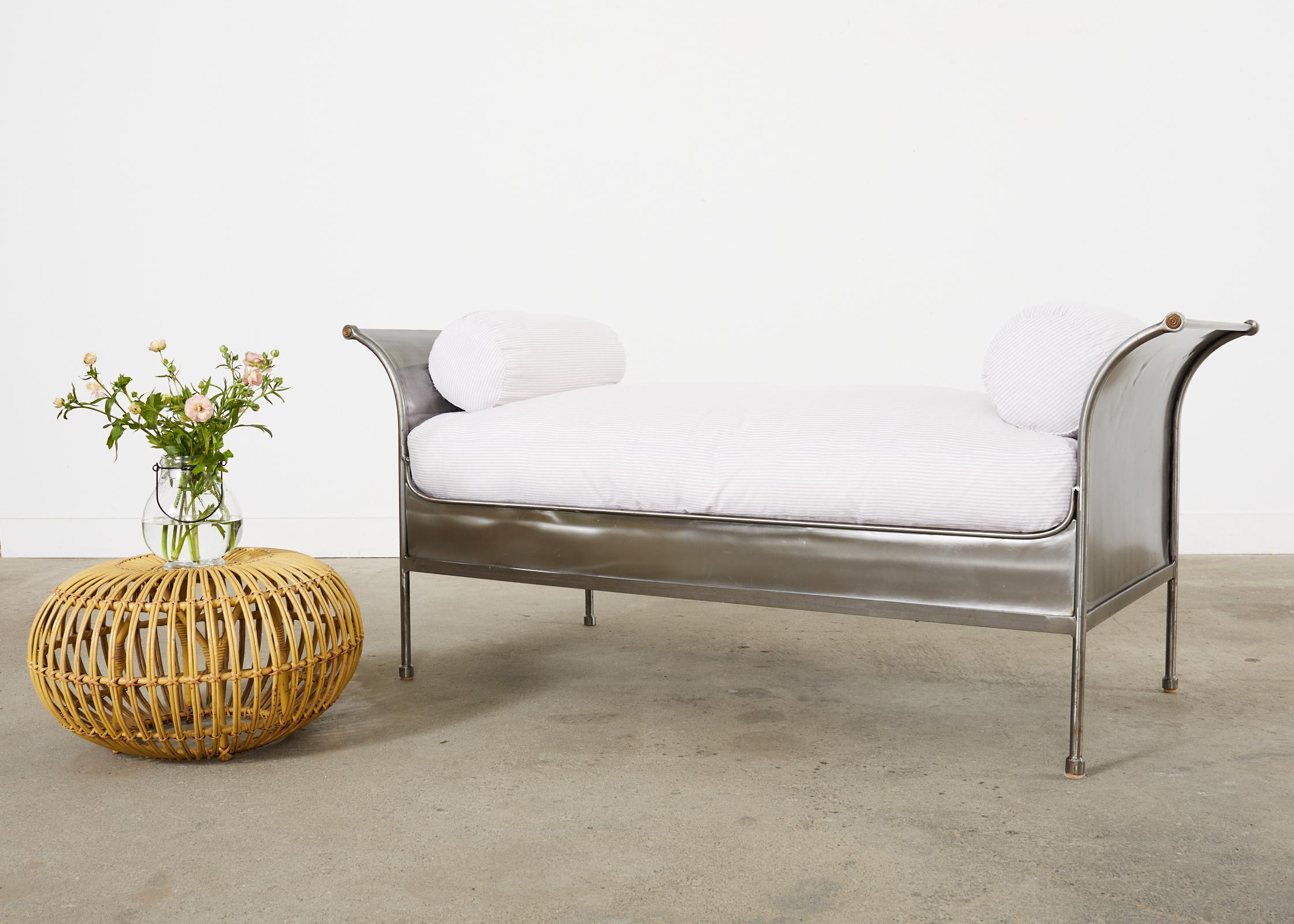Spectacular French mid-century modern sleigh daybed hand-crafted from polished steel. The bed has a dramatic patinated nickel finish made in the industrial style. Each end of the bed gracefully curves and flares out on the ends with a small bronze