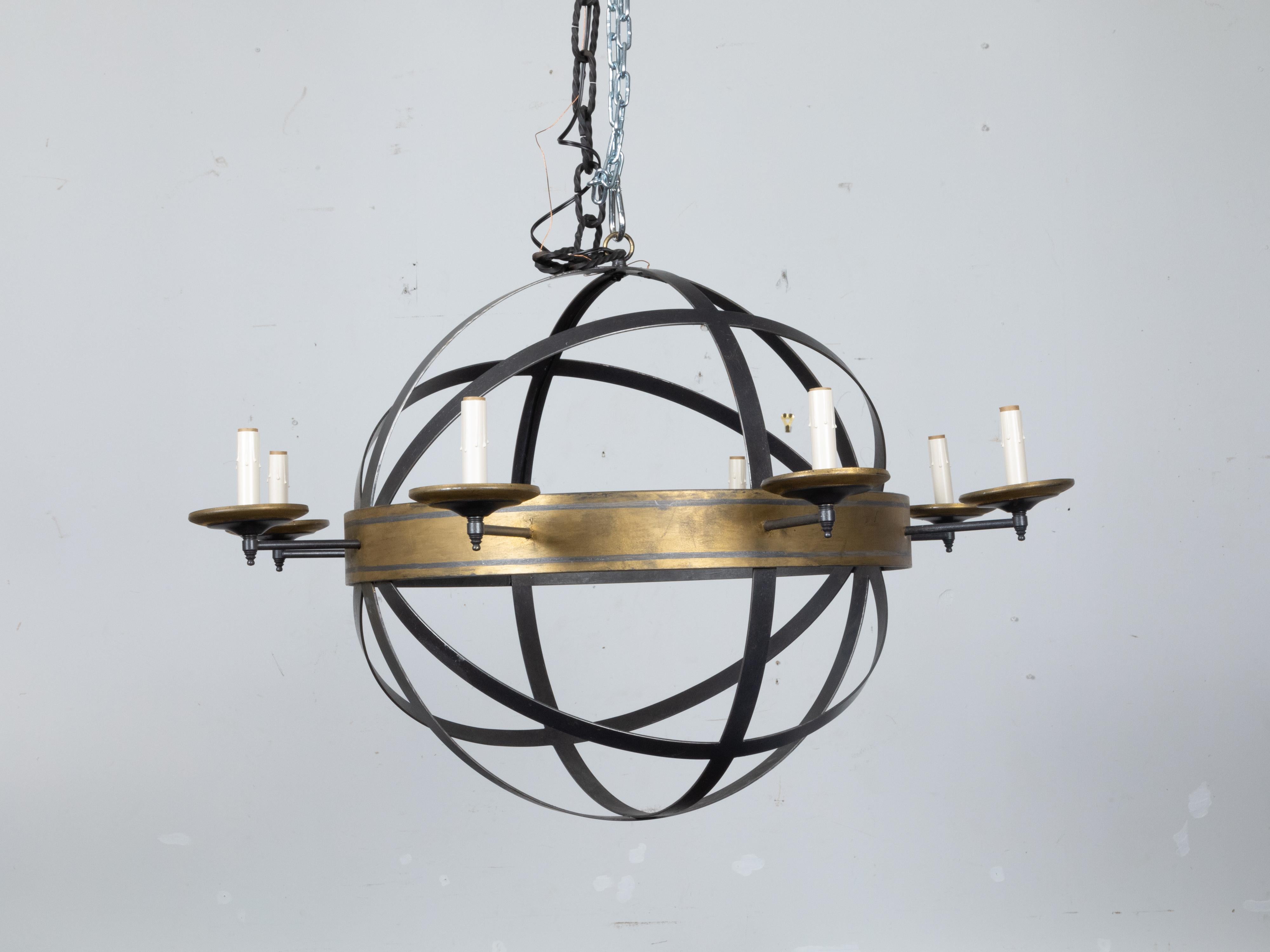 A Neirmann Weeks iron eight-light armillary chandelier. Illuminate your space with the striking allure of this eight-light armillary chandelier, a distinct emblem of design ingenuity and artisanal skill from the 20th century. Crafted with