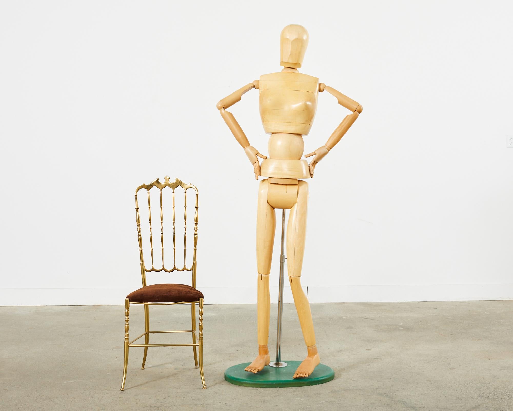 Rare mid-century modern French life-size female articulated artist model, dummy, or mannequin. Crafted from blonde beechwood the model includes a steel stand mounted to a green painted wooden plinth. Intricate fingers and toes with lovely