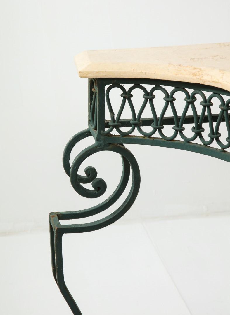 French 1950s console table in the style of Gilbert Poillerat. Green enameled wrought iron base with beige/cream beveled marble top.