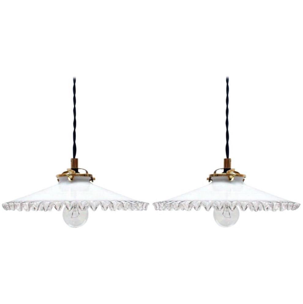 These pendant lights were made in France in the 1950s. The lamps have got white opaline pleated glass lampshades and brass holders. They have got French B22 sockets and have been rewired with new fabric wiring and are suitable for US use. The wiring