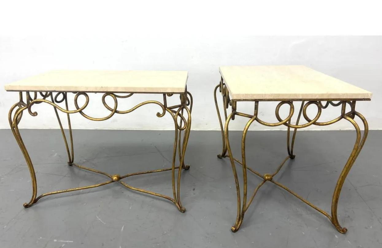Midcentury French Rene Prou Art Deco gilded iron end tables with travertine tops, circa 1940s. Lovely decorative gilt iron work with a low stretcher for stability. The tops are not secured to the bases. 