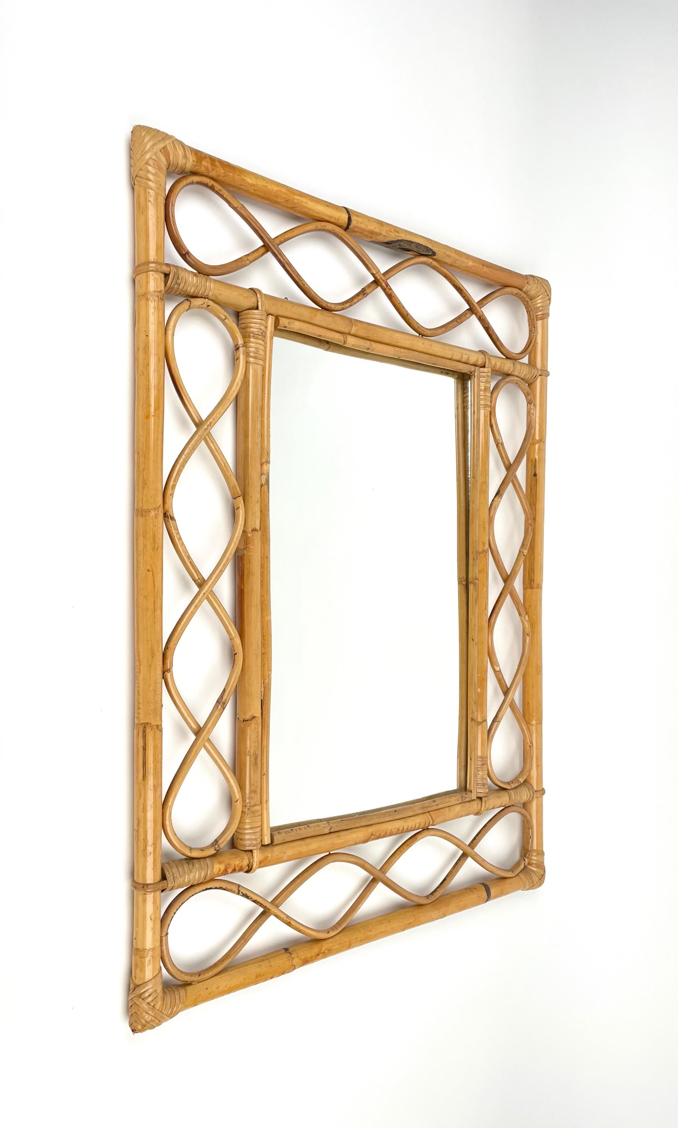 Marvellous Côte d'Azur wall mirror in bamboo and rattan. This item was produced in France during the central part of the 1960s.

The mirror its original and good vintage conditions, and the use of the materials and the lines, the straight bamboo