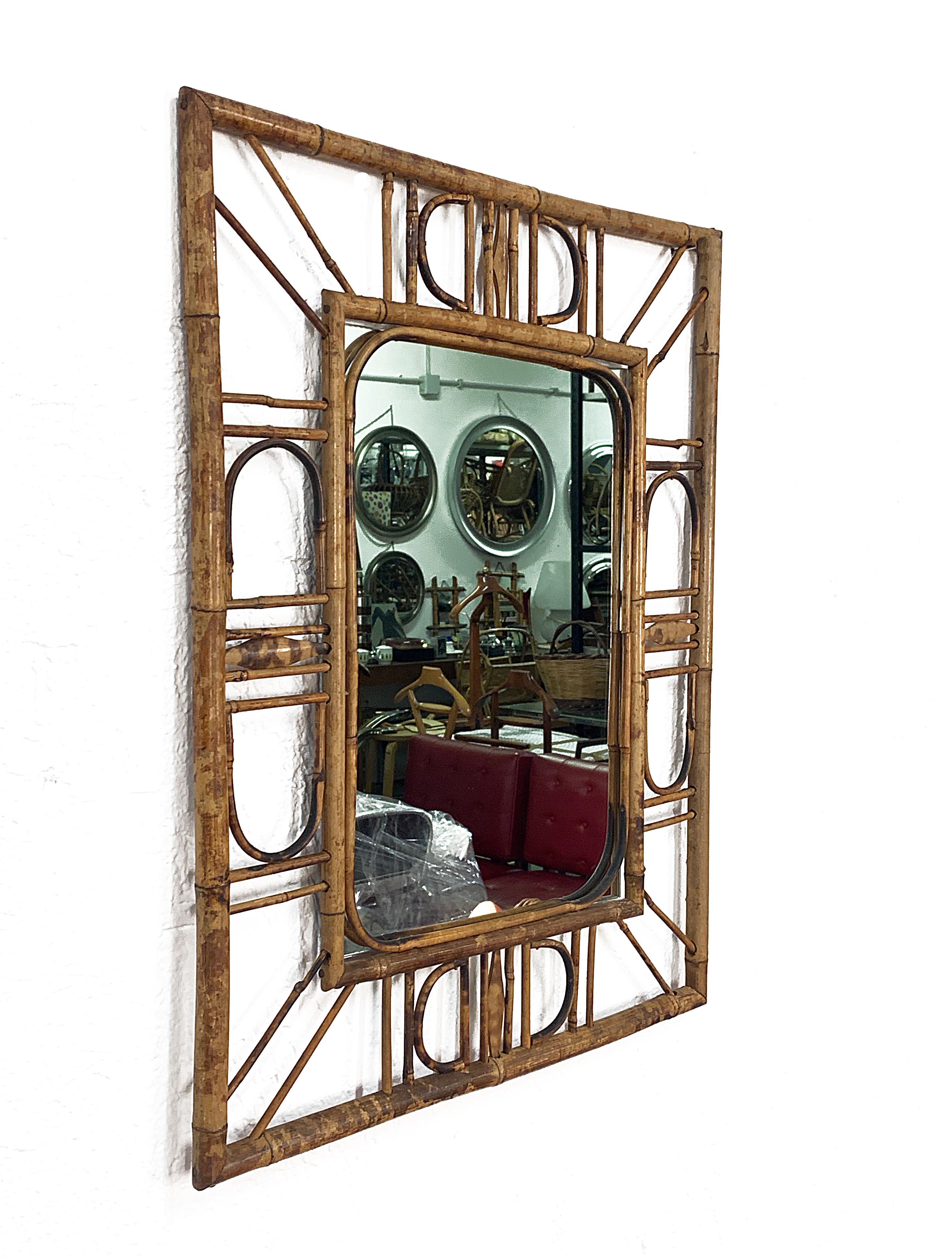 Marvellous Côte d'Azur wall mirror in bamboo and rattan. This item was produced in France during the central part of the 1960s.

The mirror its original and good vintage conditions, and the use of the materials and the lines are a clear example of