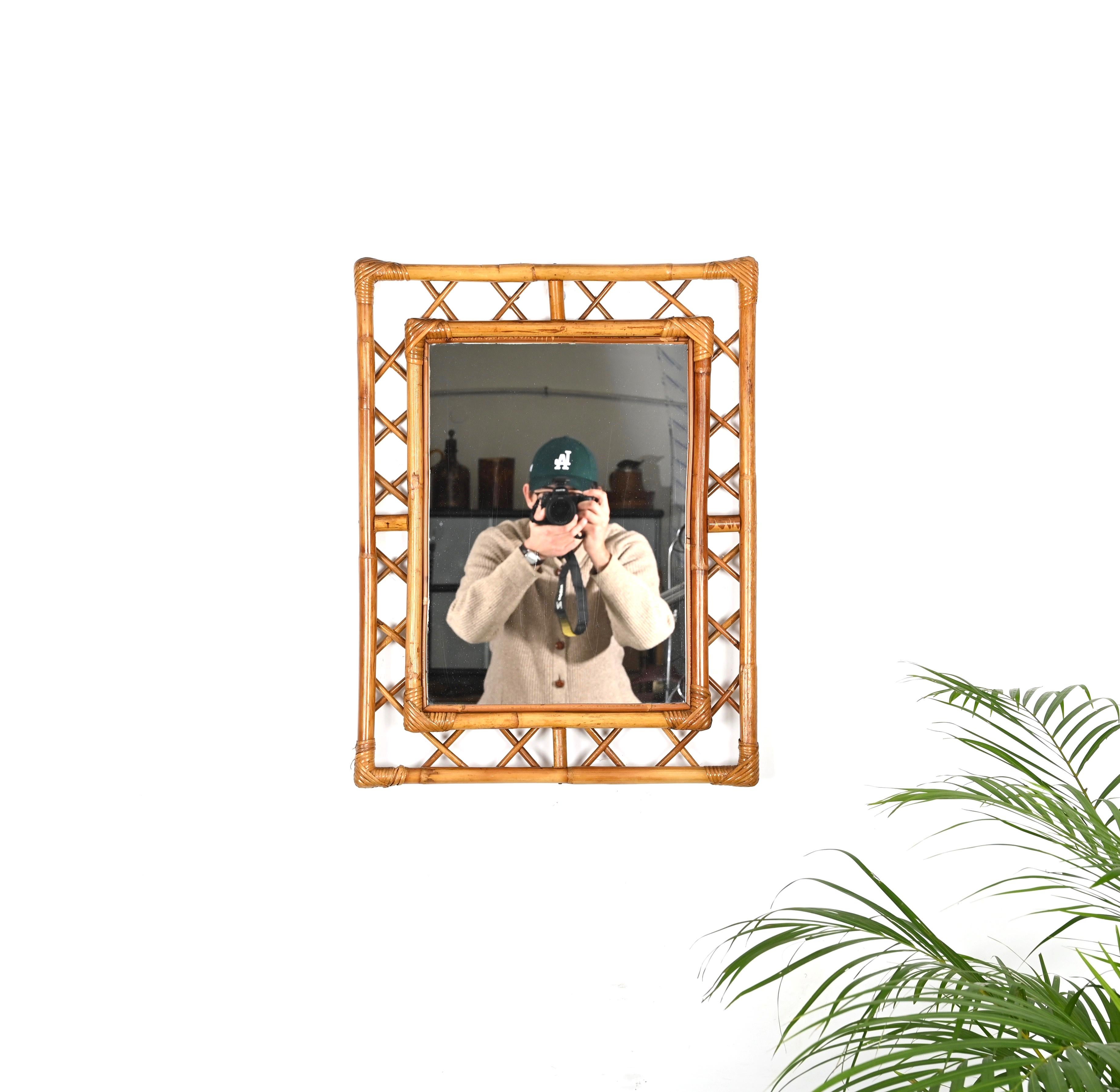 Beautiful Côte d'Azur style rectangular wall mirror in bamboo and hand-woven rattan wicker. This lovely mirror was produced in Italy during the 1960s.

This unique mirror features two rectangular bamboo frames with stunning decorations between them.