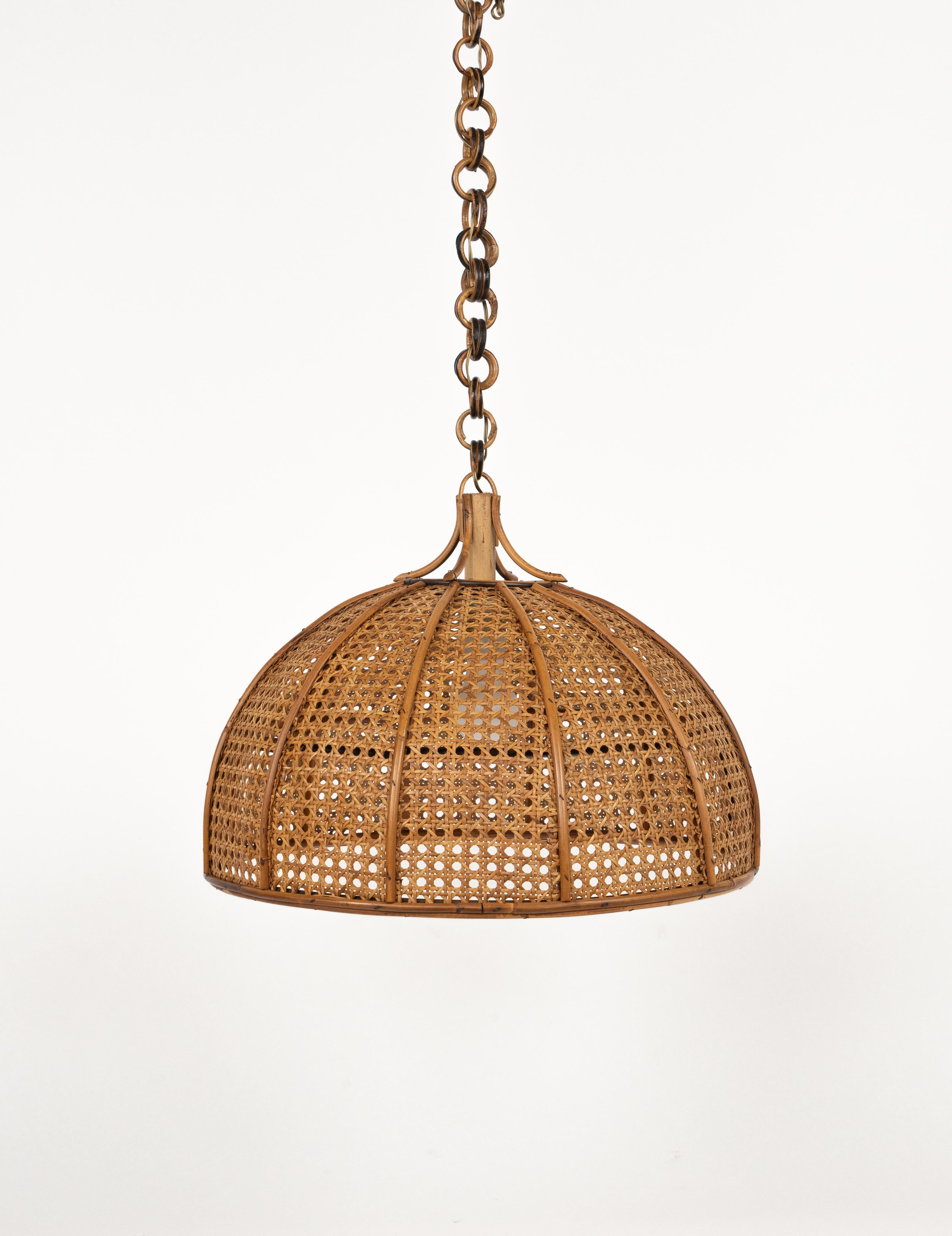 Midcentury beautiful hand-crafted chandelier in rattan and wicker with chain with round rattan links which can be shortened to adjust it to the desired height.  

Made in Italy in the 1960s.  

New electrical system, they are wired for the United
