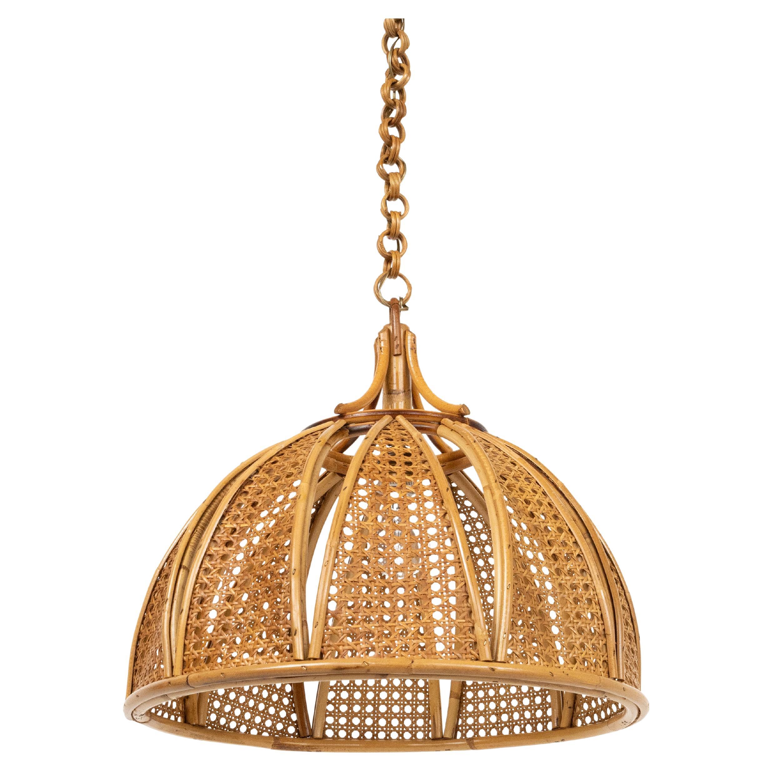 Midcentury beautiful hand-crafted chandelier in rattan and wicker with chain with round rattan links which can be shortened to adjust it to the desired height.

Made in Italy in the 1960s.

New electrical system, they are wired for the United States