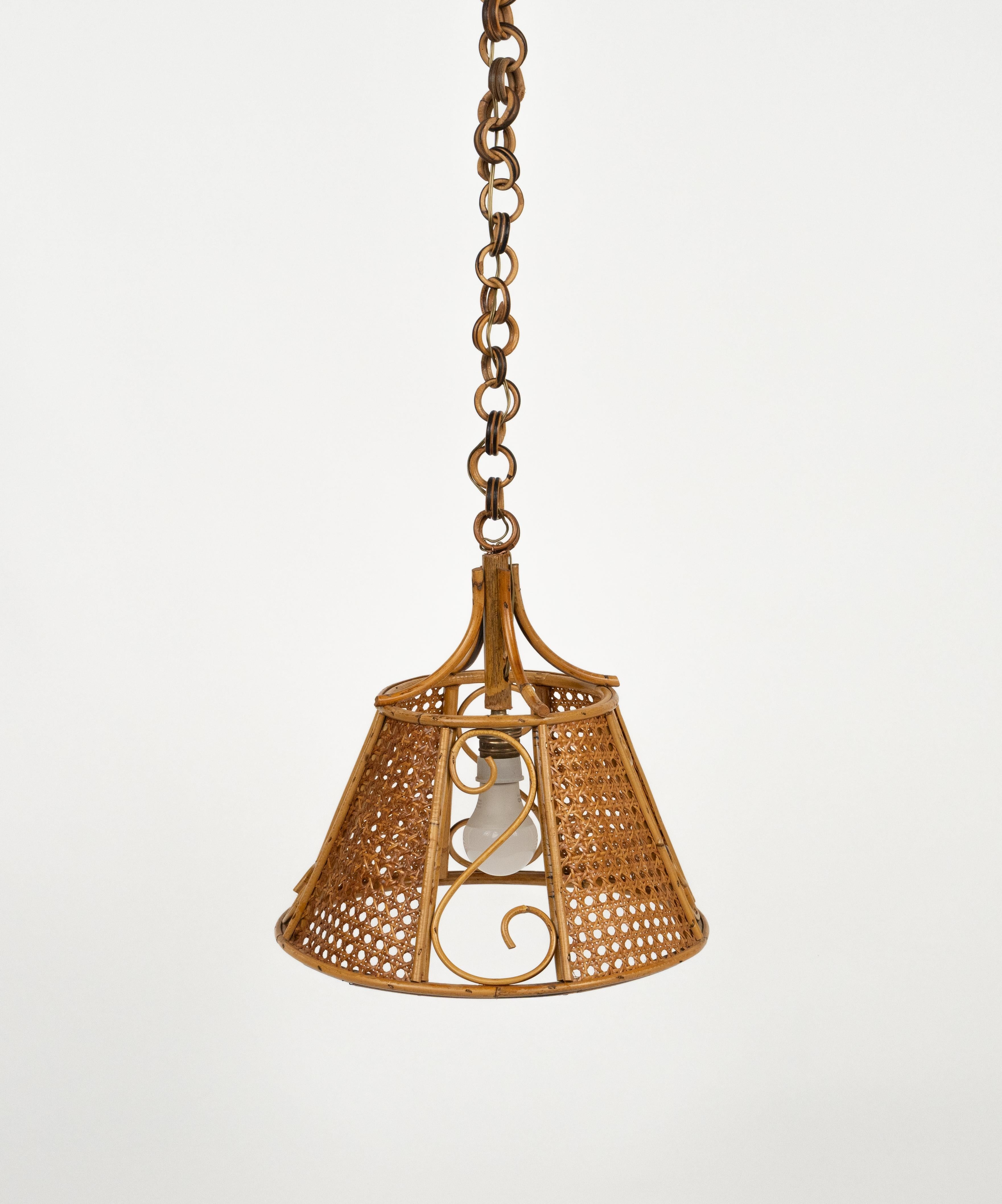 Midcentury beautiful hand-crafted chandelier in rattan and wicker with chain with round rattan links which can be shortened to adjust it to the desired height.  

Made in Italy in the 1960s.  
 
New electrical system, they are wired for the United