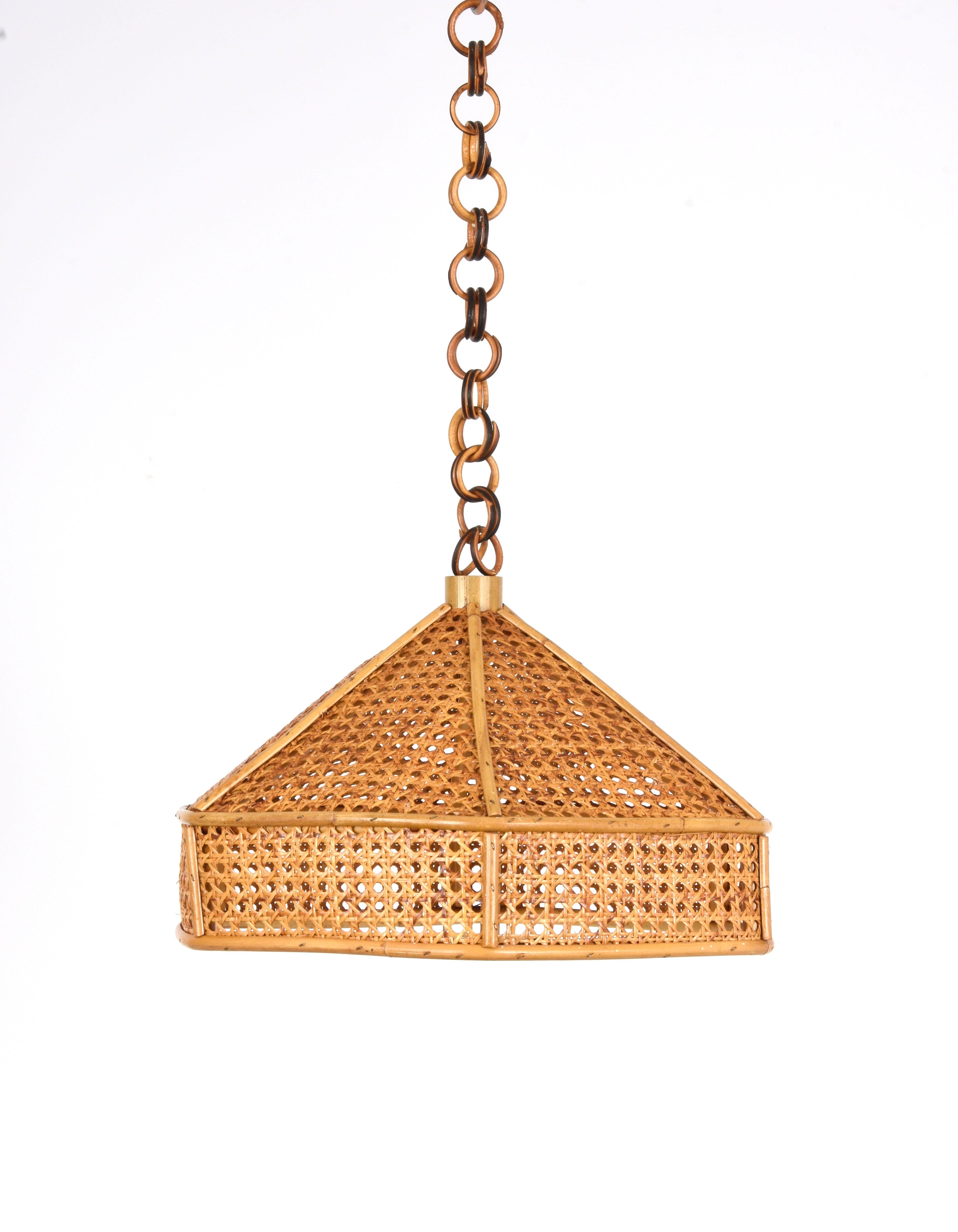 Wonderful rattan and wicker pendant chandelier in the French Riviera style. This incredible piece was made in Italy in the 1960s.

This item is surprising because of the bamboo chapel and a wicker cover structure.

This chandelier is perfect for
