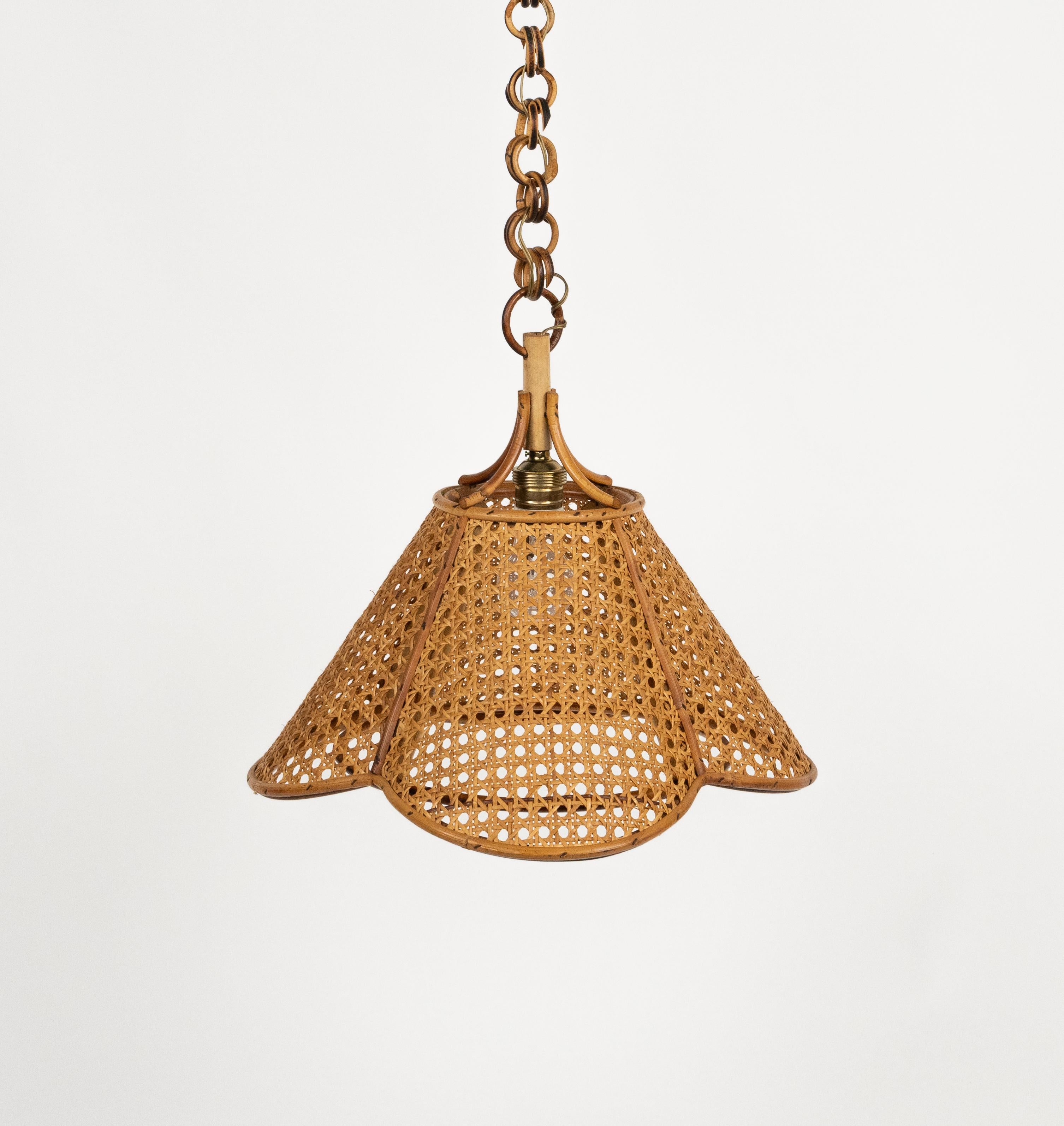 Midcentury beautiful hand-crafted chandelier in rattan and wicker with chain with round rattan links which can be shortened to adjust it to the desired height.  

Made in Italy in the 1960s.  

New electrical system, they are wired for the United