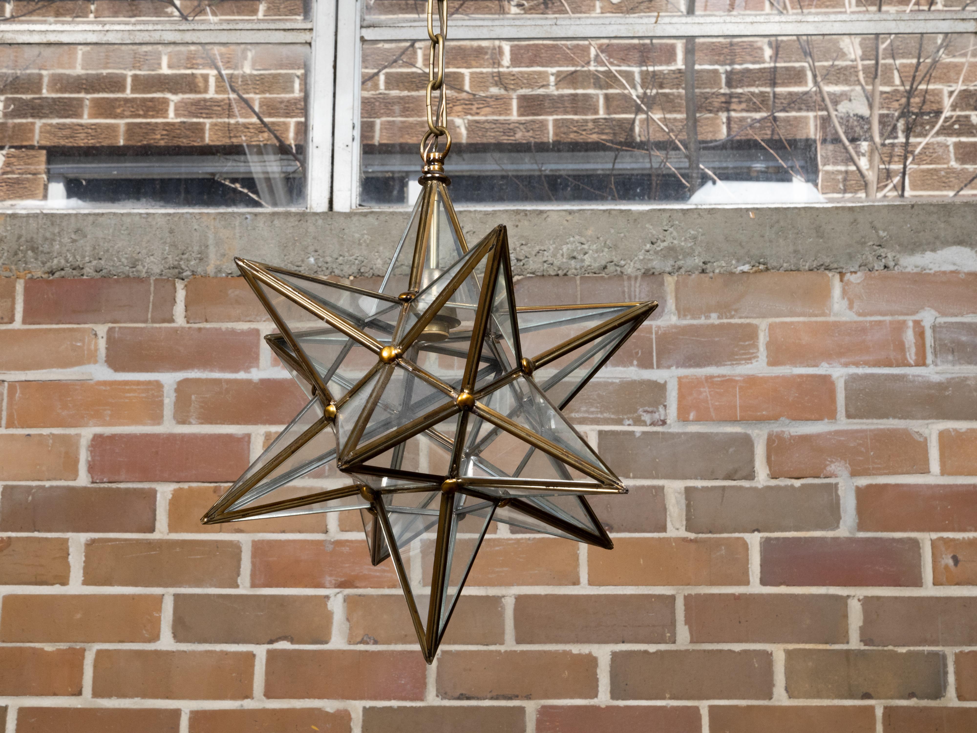 A French Midcentury star light fixture with glass panels surrounding a central socket, rewired for the USA. This French Midcentury star light fixture epitomizes the elegance and geometric allure of the era. Constructed from a durable metal