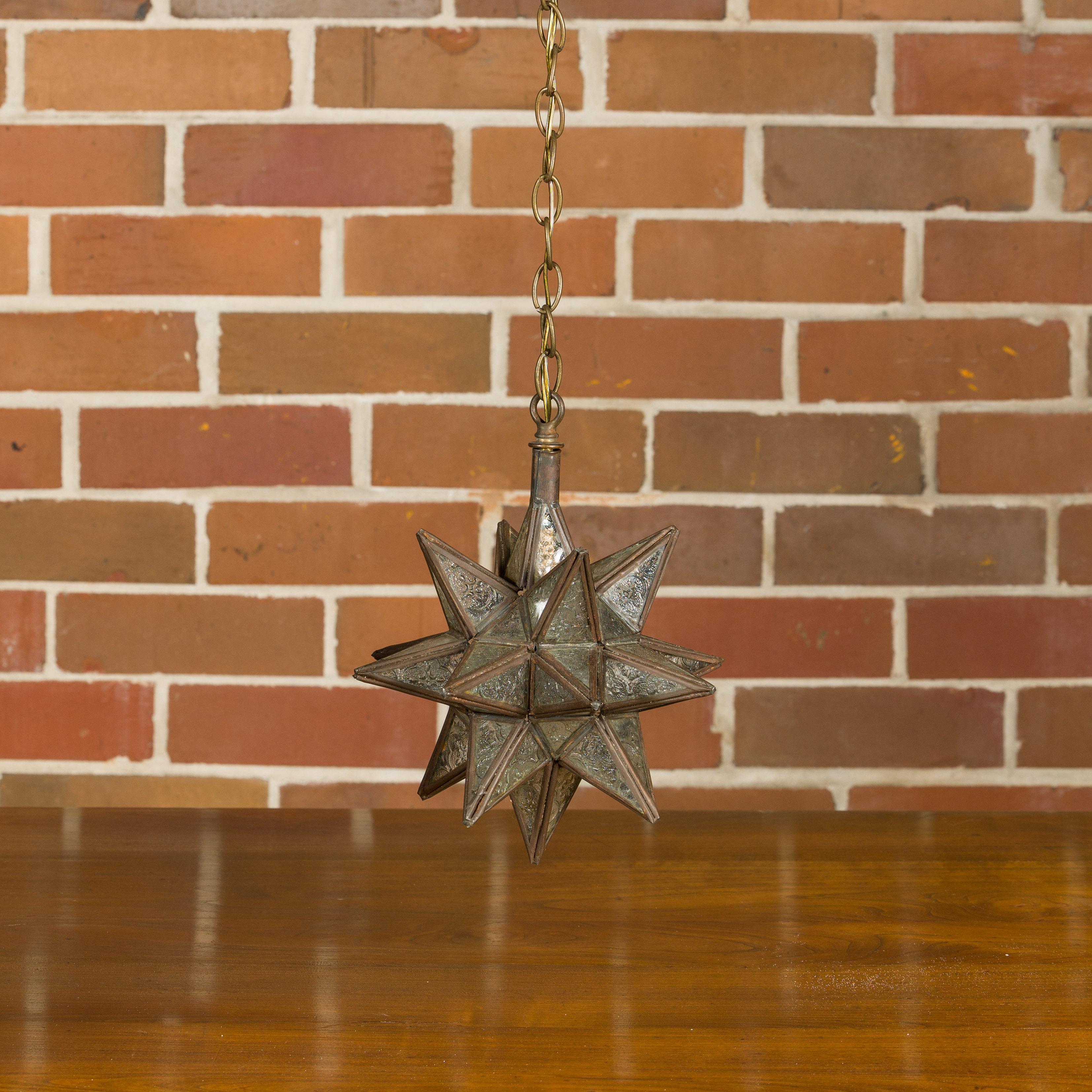 A French Midcentury star light fixture with textured glass panels surrounding a central socket. Dive into the celestial allure of this French Midcentury star light fixture, a captivating addition to any interior space that yearns for a touch of