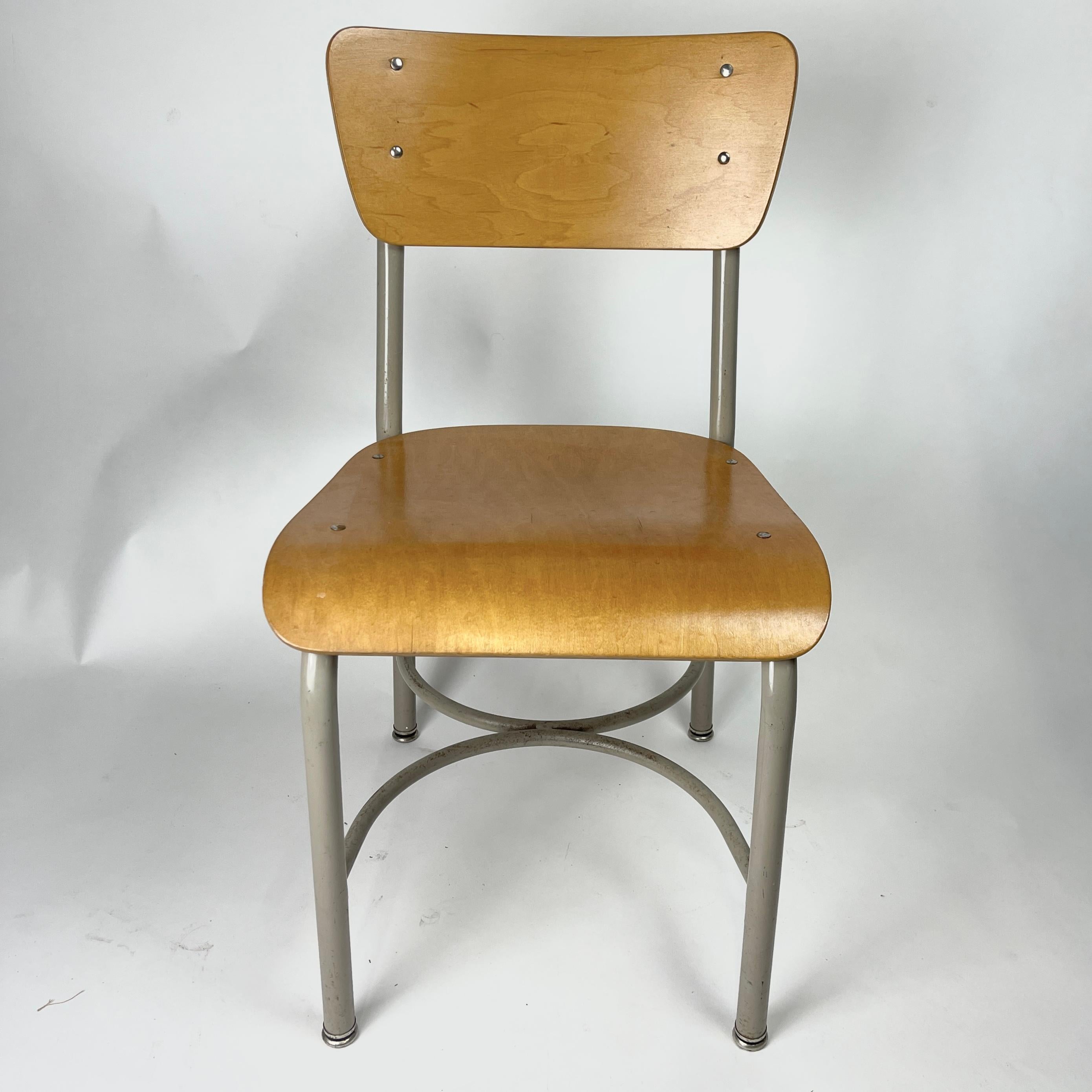 40 available. Elegant grey framed school chairs with bent birch plywood seats and backs. These are vintage midcentury school chairs that would look great in a rustic or more contemporary kitchen or casual dining area. These are perfect for a cafe or