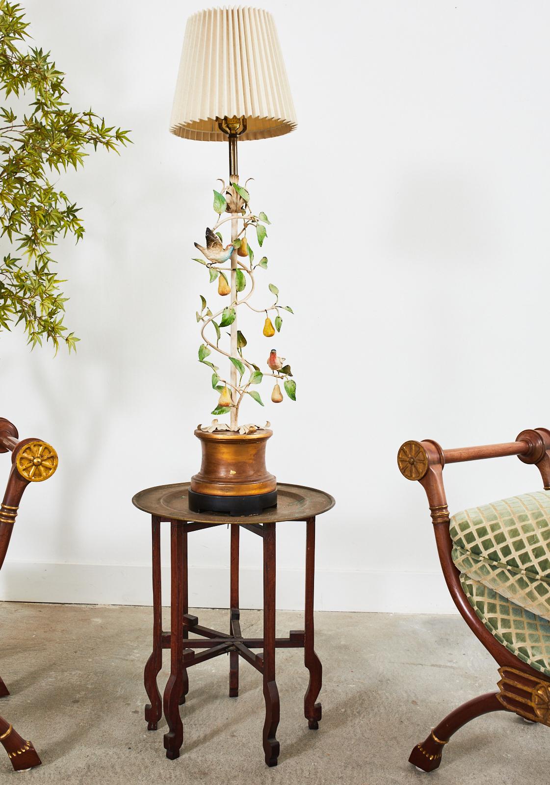 Ornate mid-century modern table lamp designed by Leonard Foss in California. The charming lamp features a column of twisting pear tree vines with delicate birds and foliate. Crafted from tole and beautifully painted. The column is decorated with