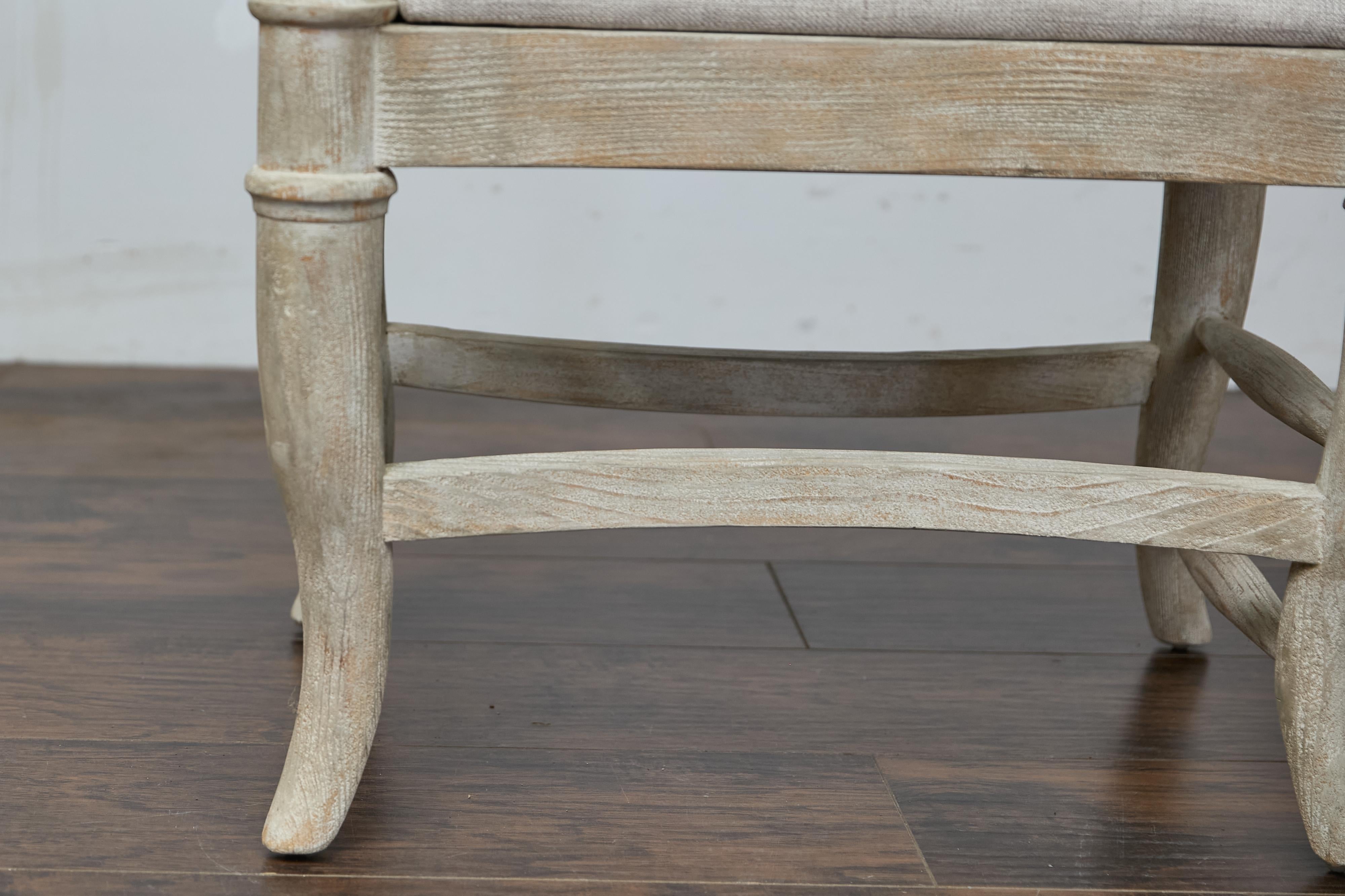 Uno sgabello francese del Midcentury con gambe ricurve, barelle laterali e una nuova imbottitura personalizzata. Questo delizioso sgabello francese del Medioevo ci charme con le sue linee e la sua elegante finitura imbiancata. Lo sgabello si regge