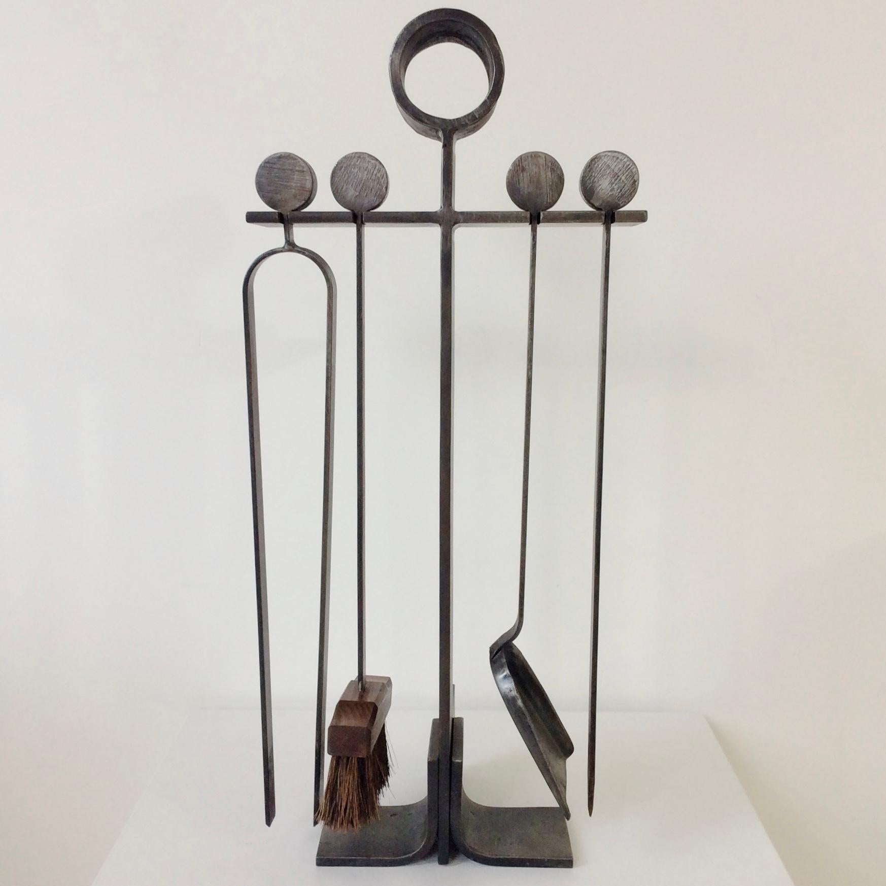 Elegant midcentury wrought iron fireplace tools, circa 1960, France.
Circular handles.
Fire place tool set consisting of a shovel, brush, poker and log grabber.
Dimensions: 60 cm H, 28 cm W, 18 cm D.
All purchases are covered by our Buyer