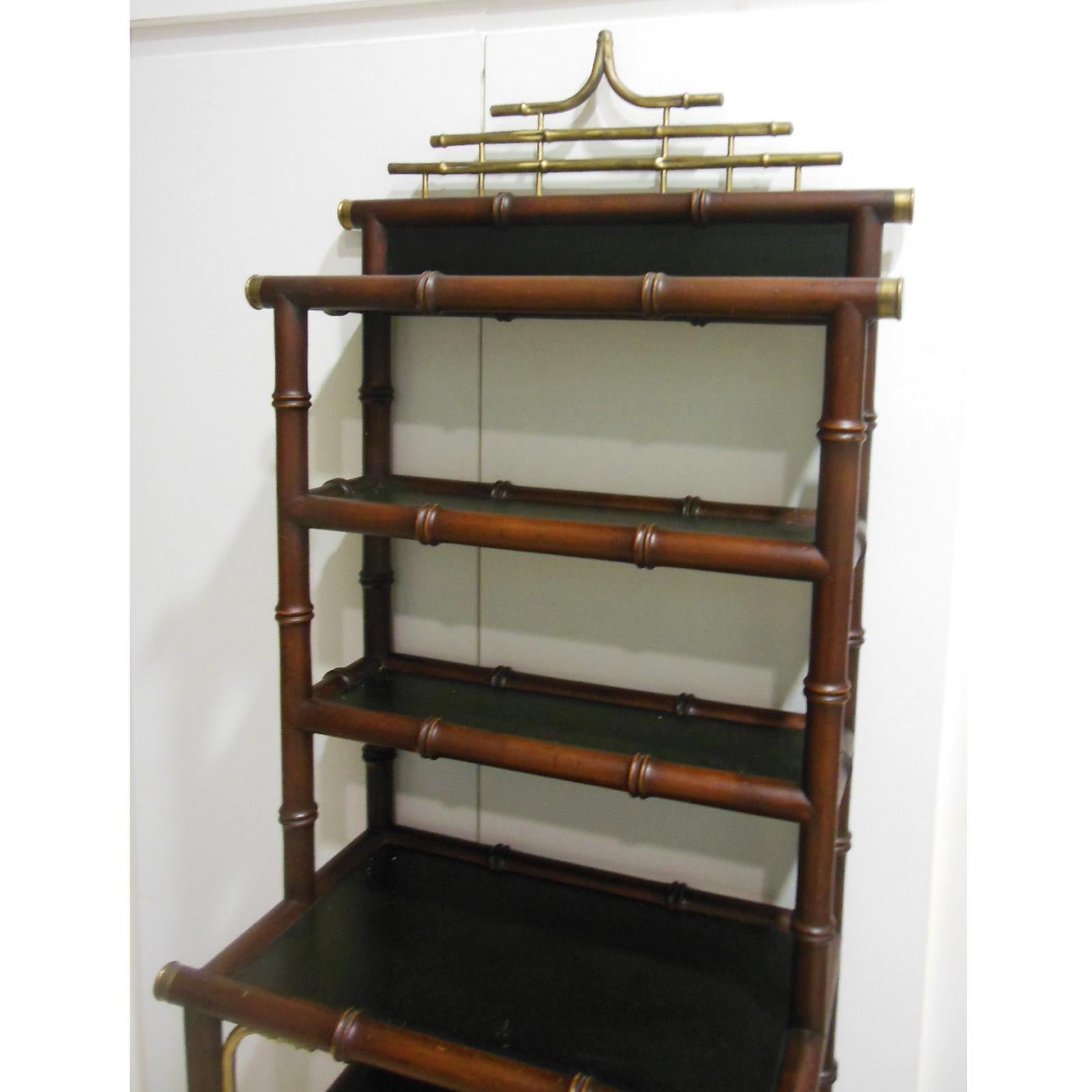 Chinese Chippendale Style shelves features pagoda form, 1950s

Has 4 shelves in the lower parade and 3 in the narrower upper one

Made of fine wood in the shape of faux bamboo and brass on the links and the upper part of the pagoda and green