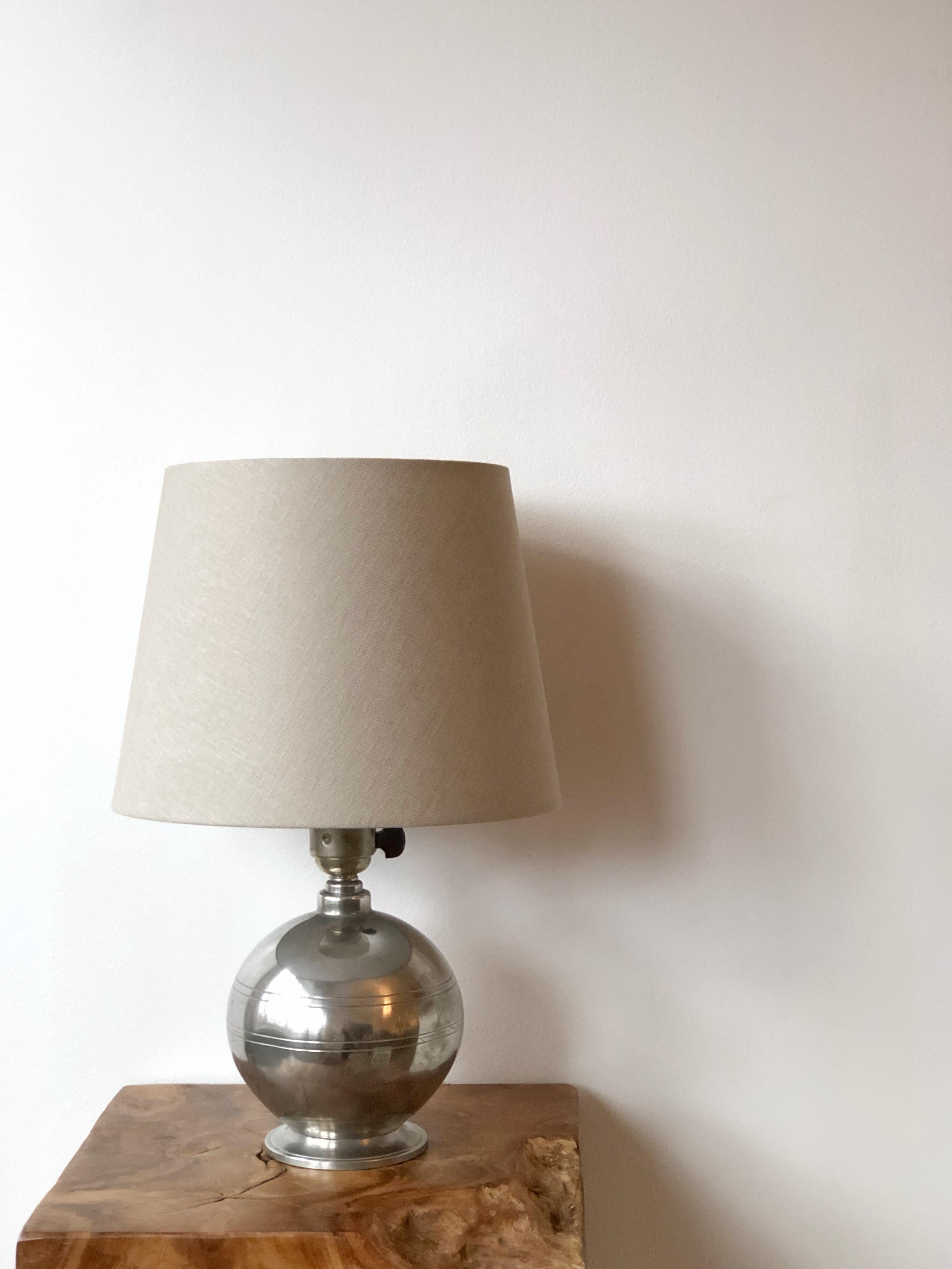 A Scandinavian Modern spherical pewter table lamp with a series of horizontal groves. Made by G.A.B. (Guldsmedsaktiebolaget), circa 1930s.

Good condition with light age related wear and patina.
New American wiring.
Shade is not