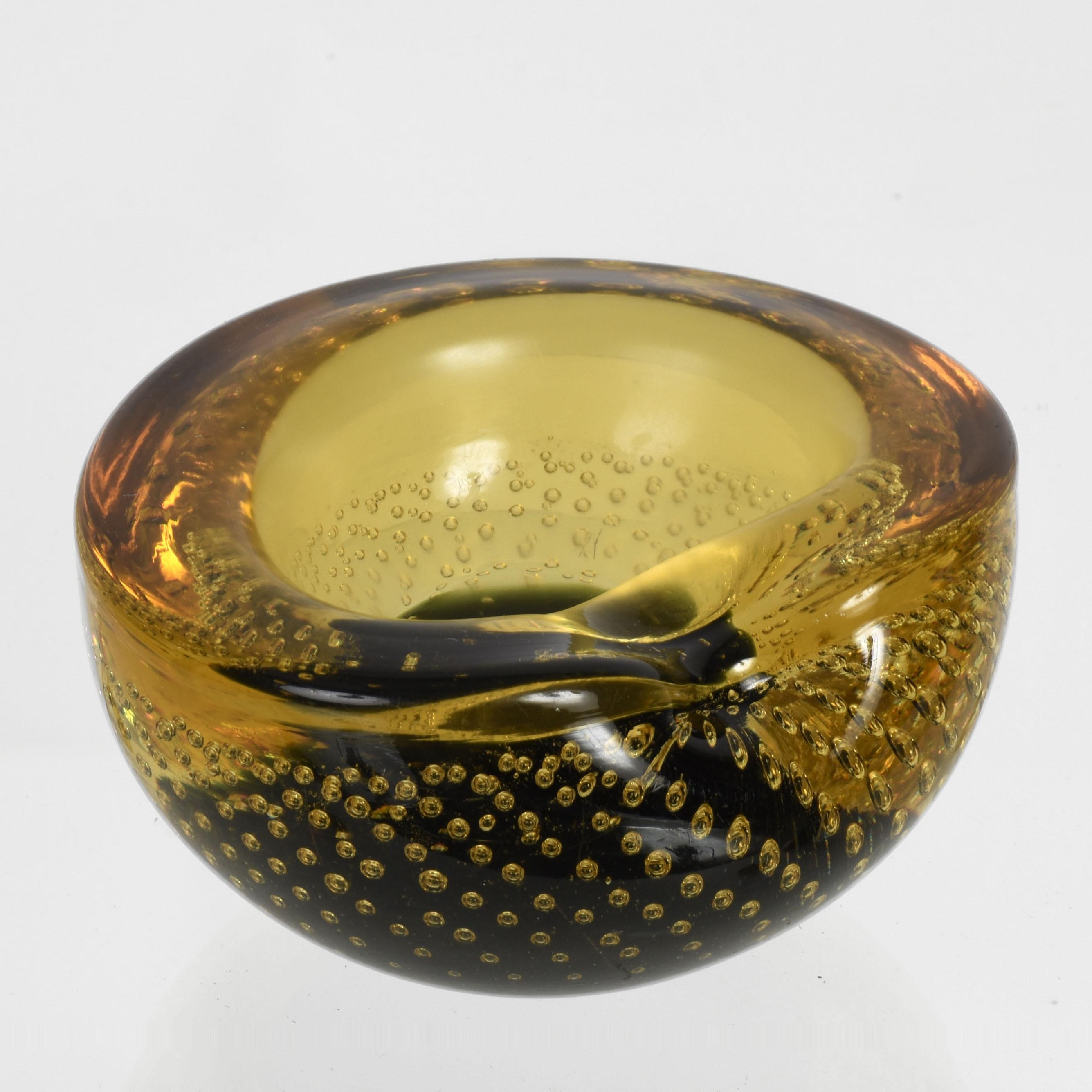 Spectacular midcentury decorative bowl in amber, yellow and blue Murano glass with air bubbles (bullicante). This wonderful piece was produced in Italy during the 1960s and it is attributed to Galliano Ferro.

This piece is unique for the elegant