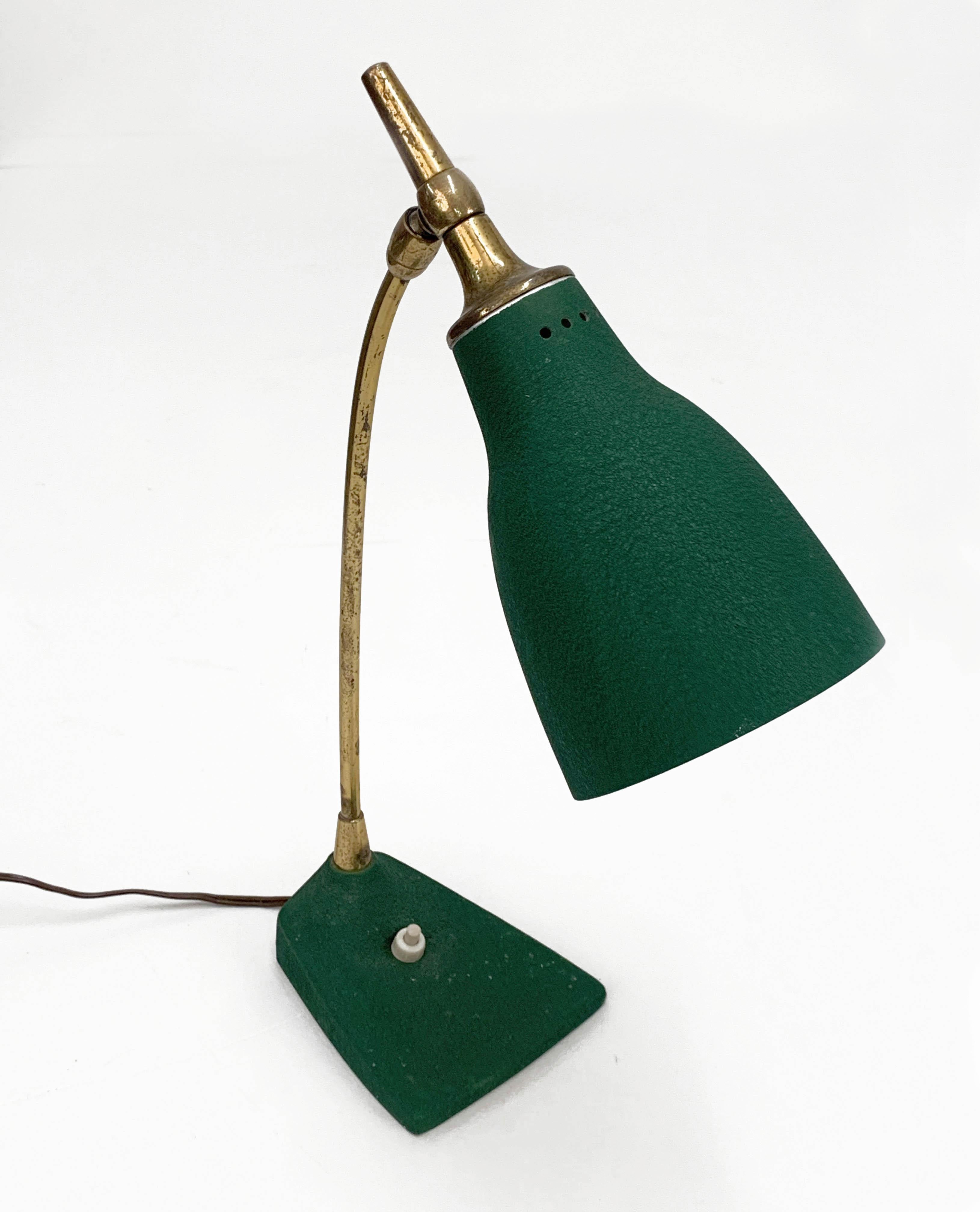 Amazing midcentury adjustable green brass with aluminium shade and cast iron base. This marvelous table lamp was designed by Gebrüder Cosack during the 1950s.

This table lamp is a perfect mix of materials, the green cast iron base, the sinuous