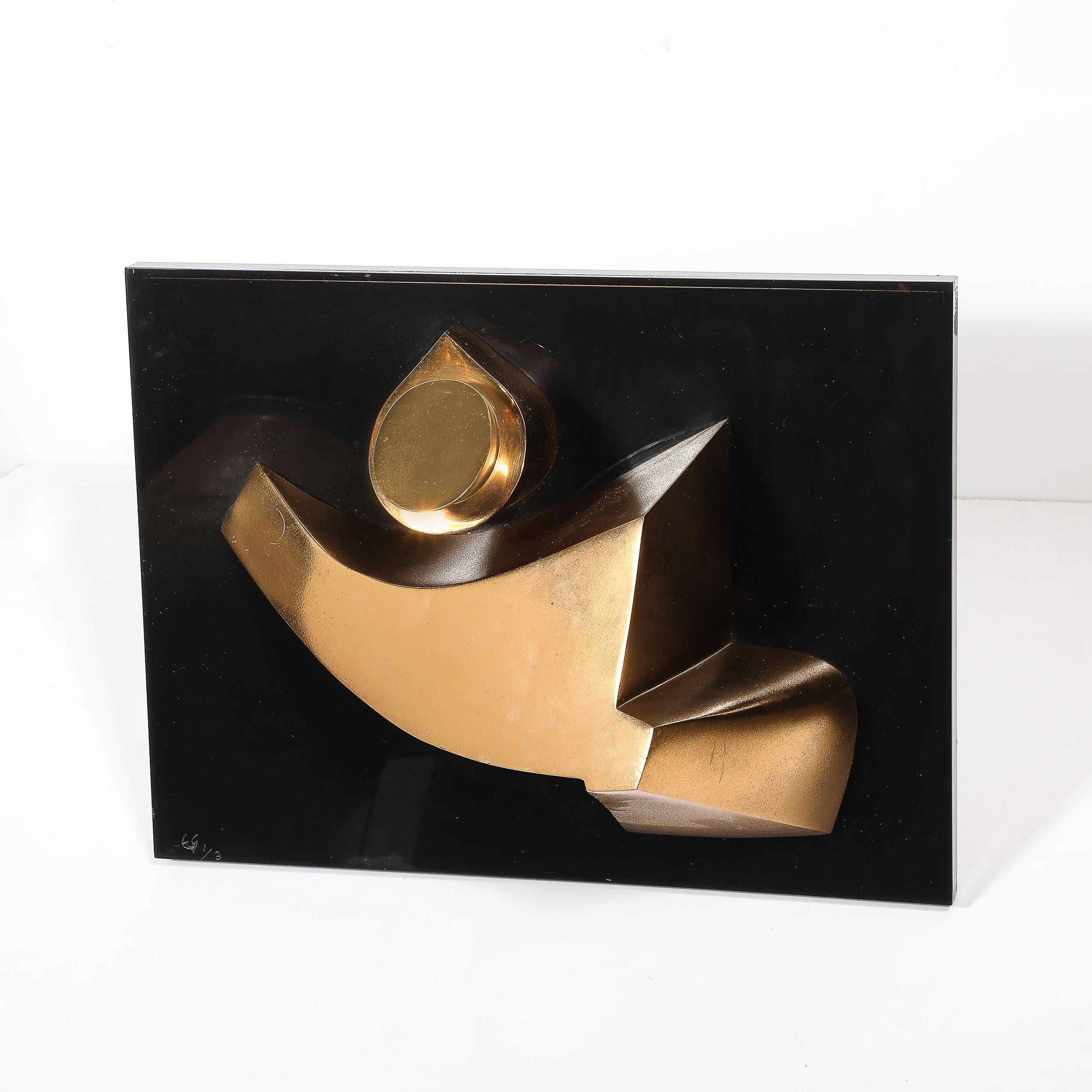 This Mid-Century Modernist geometric abstract wall sculpture by Emile Gilioli is a rare and striking creation, crafted in gilt bronze and mounted on a sleek black acrylic base. Signed by the artist and marked as edition 1/3, this piece captures the