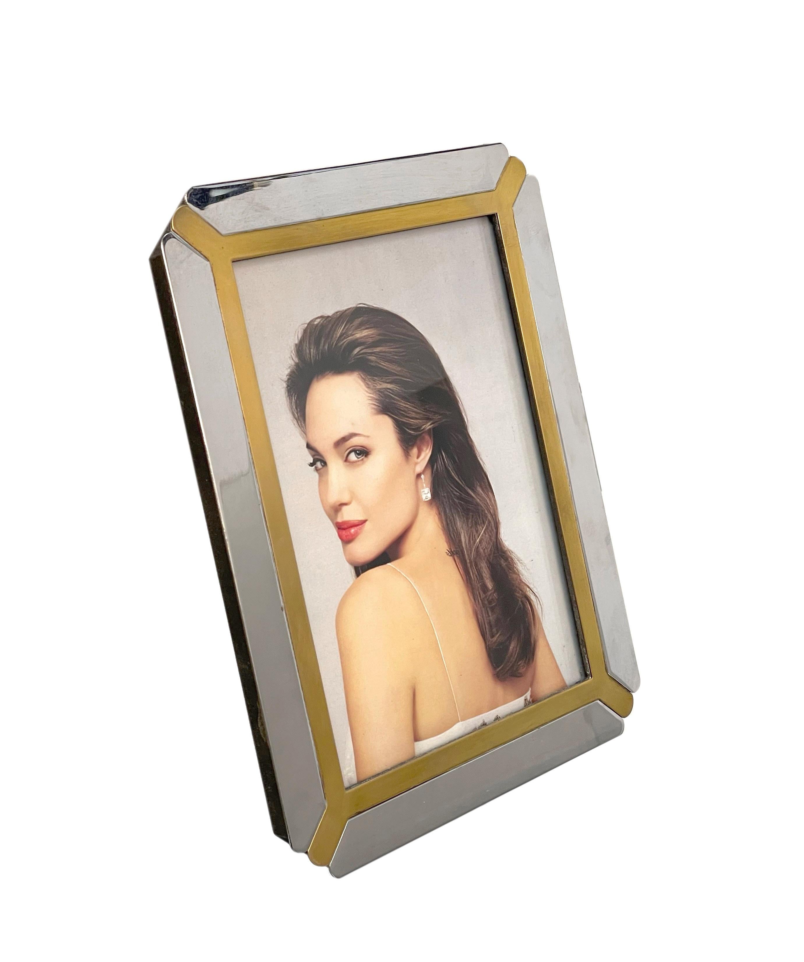 Amazing mid-century brass and chrome picture frame. This marvellous item was produced in Italy during the 1970s under the strong influence of Romeo Rega..

 The inspiration to the design of this Italian master it is visible through the combination