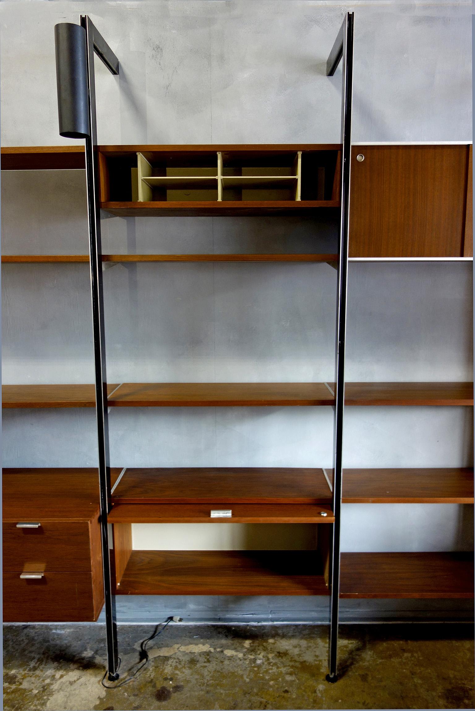 This 4 bay CSS wall unit is a Classic! Features 11 x 12'' shelves, one sliding door cabinet, one 4 drawer cabinet, one two drawer plus file cabinet. One pigeon hole cabinet, and one slide-up door cabinet. Also included are 3 can lamps. All resting