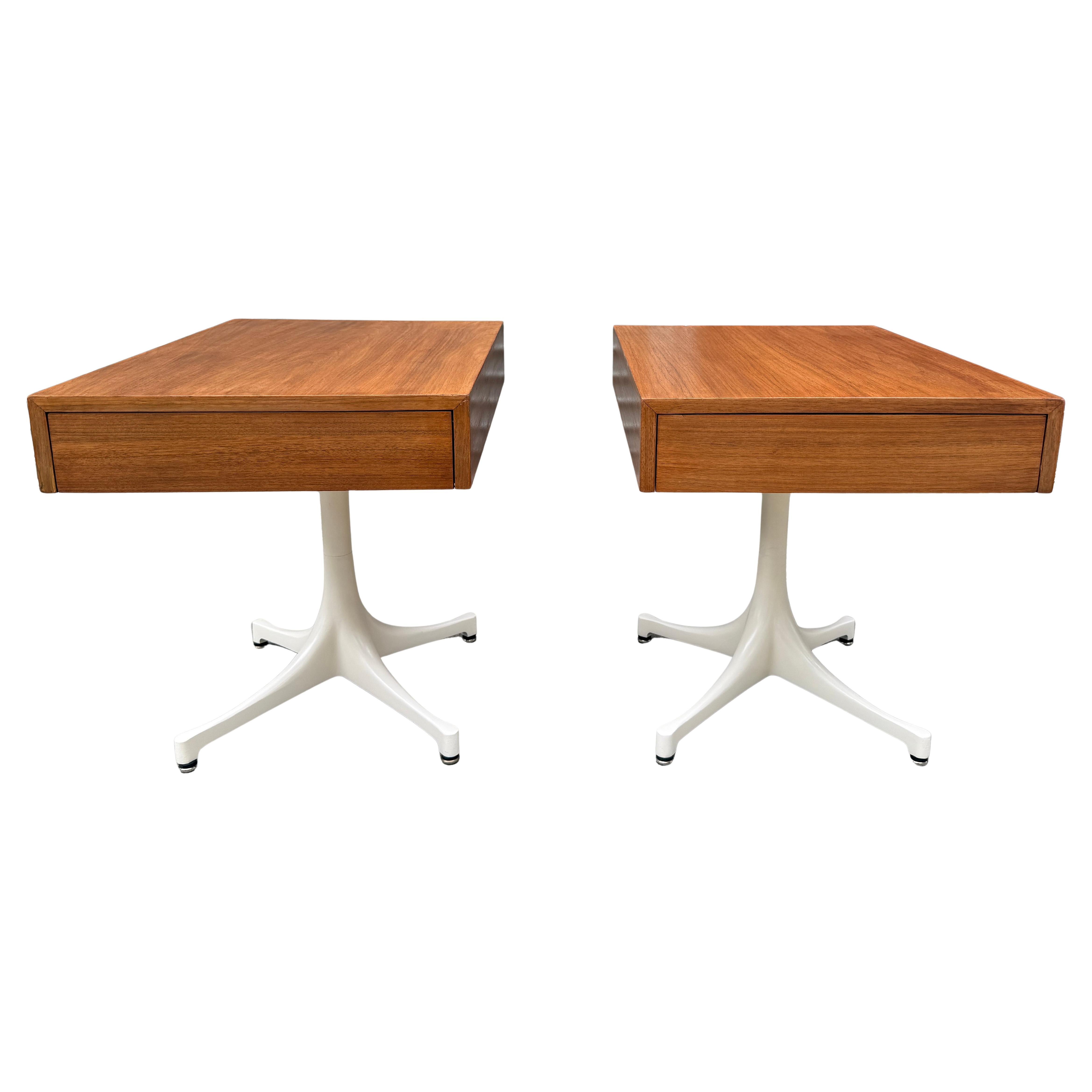 A striking and rare pair of pedestal end tables, model #5655, designed by George Nelson for Herman Miller. Crafted in walnut with enameled steel and aluminum bases, these tables embody Nelson’s forward-thinking modernist vision. Hard to believe