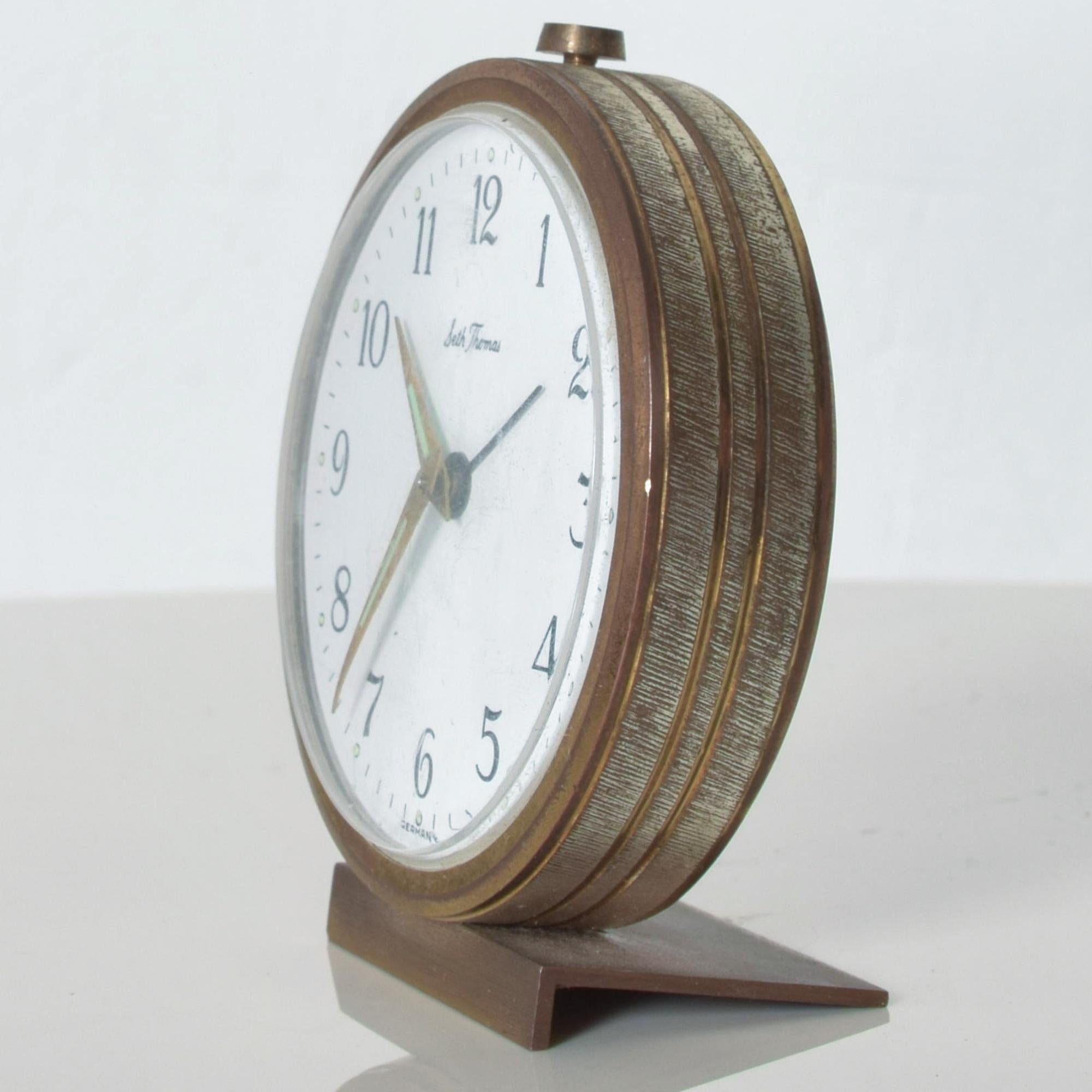Seth Thomas German miniature brass alarm wind up clock elegant midcentury 1950s made in Germany.

Dimensions: approximately 3.38