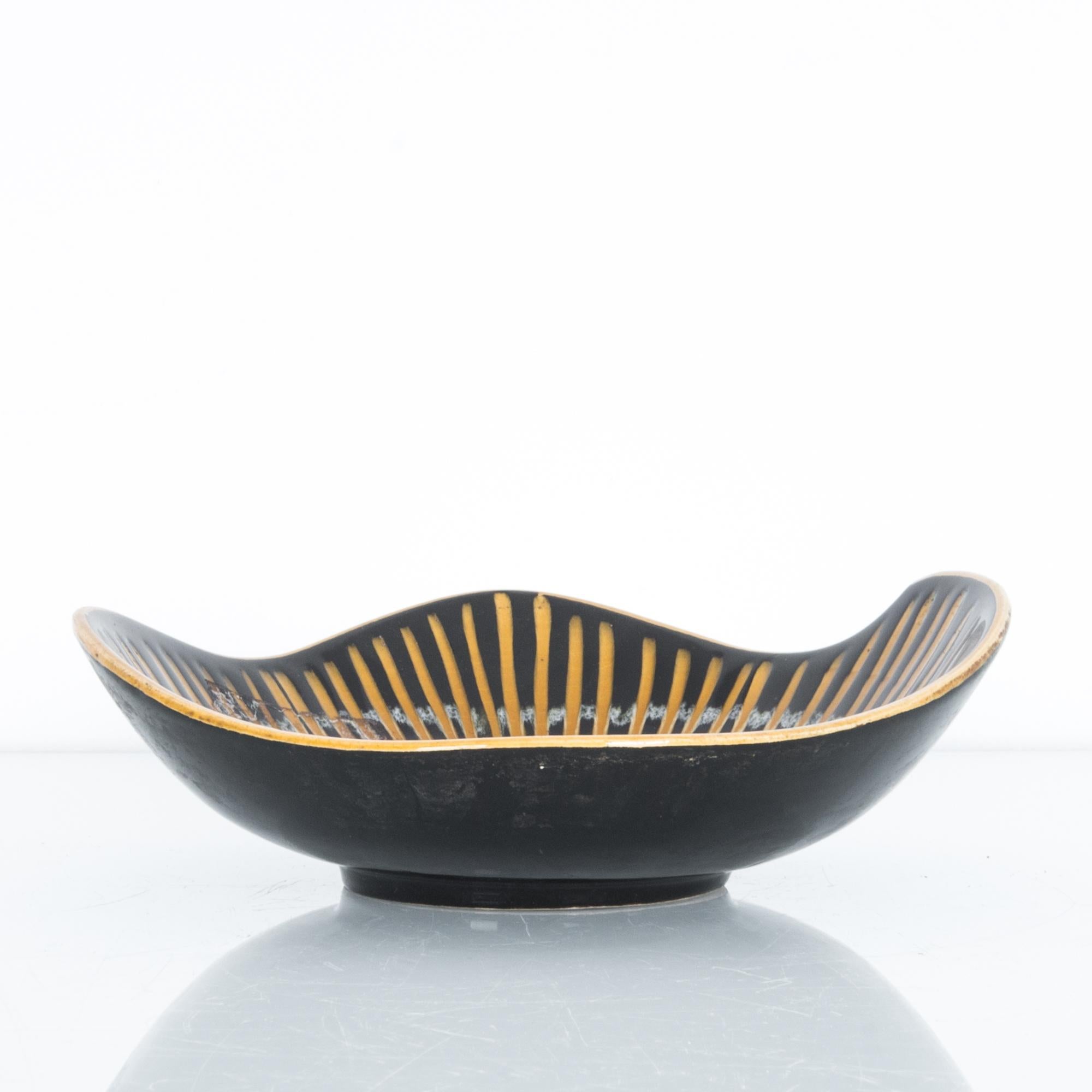 A graphic black and yellow striped platter from Germany, circa 1950. These characteristic mid-20th century ceramics were produced in West Germany, featuring “W. Germany