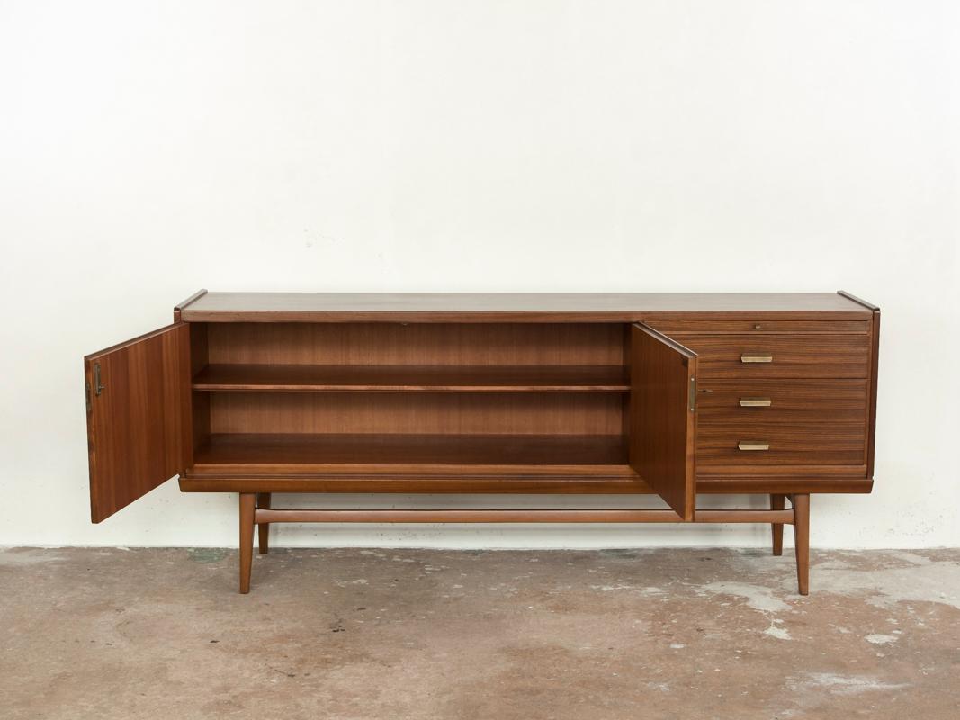 Midcentury sideboard manufactured by Bär Möbel in Germany in the 1960s. Bär Möbel means 'Bear Furniture' in German. The sideboard has 2 doors, 3 drawers and a serving plate. It is made of zebrano wood with metal drawer handle and a stained beech