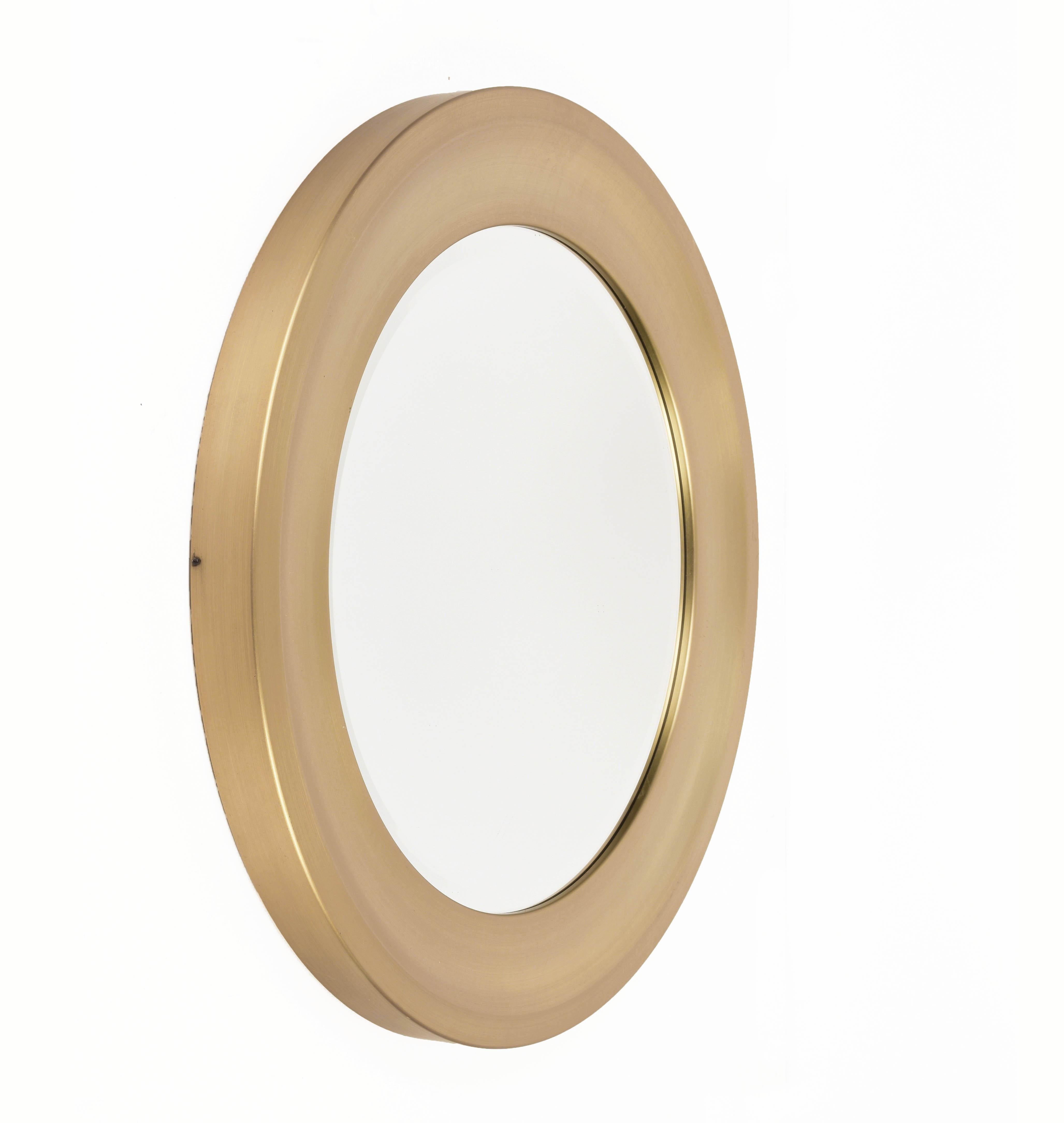 Amazing midcentury gilded aluminum frame round bevel mirror. This item is attributed to Sergio Mazza for Artemide in Italy during 1960s.

The original mirror in the center is in excellent condition and the frame has a concave center which creates