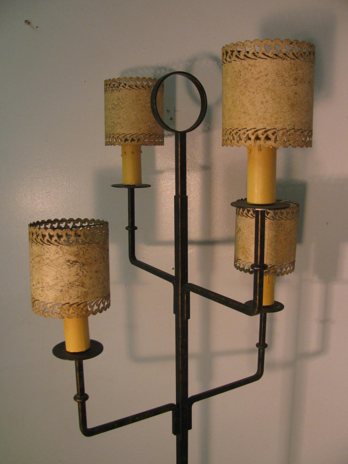 Simple and elegant iron floor lamp. Iron is delicately gilt, actually hard to see in the photos. Four light lamp with the switch at the base. Base is 12in. square