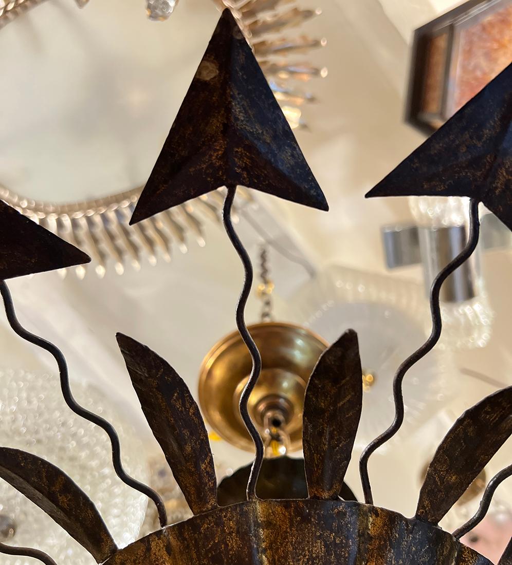 A circa 1950's French gilt metal light fixture with glass insets, with 3 candelabra interior lights.

Measurements:
Height of body: 5.5