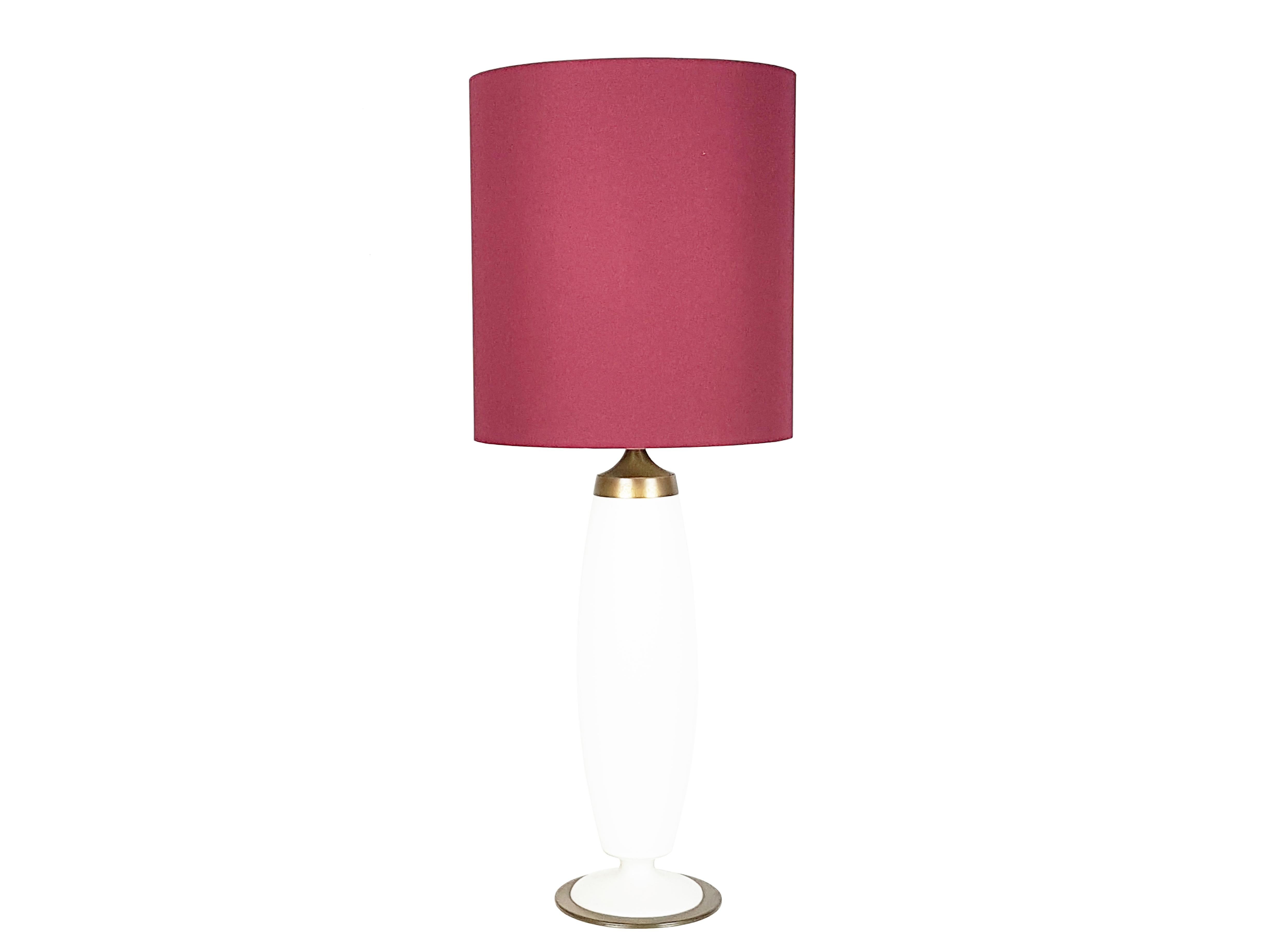 This fine table lamp is made of opaline satin finish glass with brass details and it remains in very good conditions: some paint losses on the lamp holder, as showed in picture. Available in bordeaux shade version.