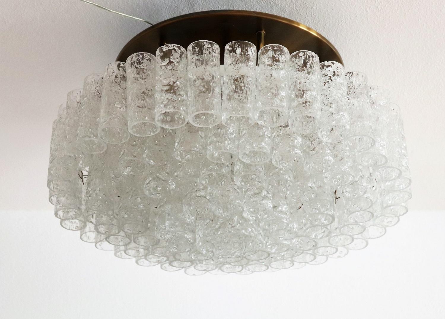 Gorgeous big chandelier or flush mount lighting with brass ceiling plate and 97 ice glass parts, all in excellent condition.
Made in Germany in the 1960s, with original DORIA lable.
The ceiling plate is equipped with 9 bulb holders for small bulbs