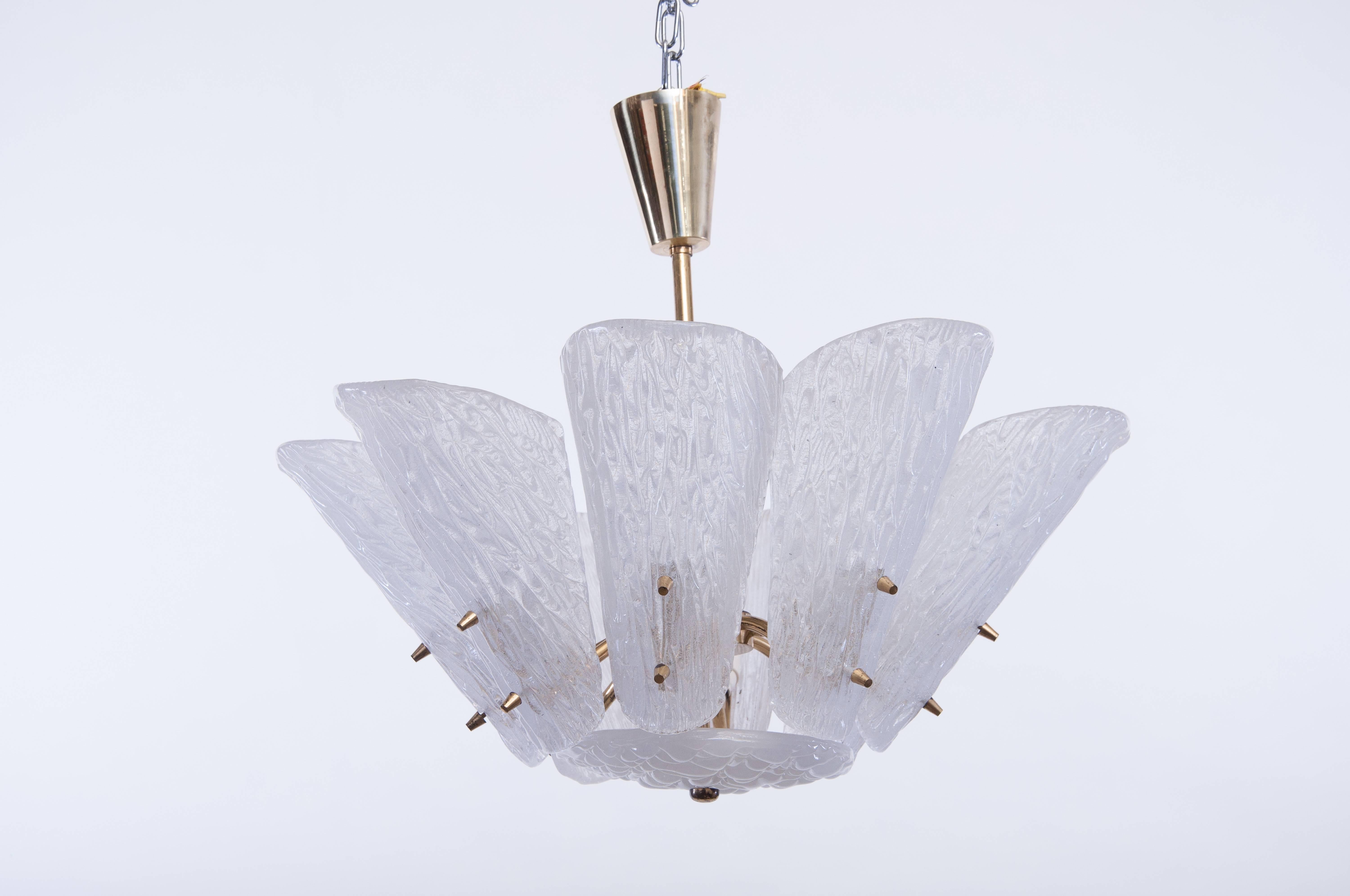 One large Viennese midcentury textured milky colored glass and brass pendant lights or chandeliers by J. T. Kalmar, Austria, manufactured in the 1950s. Each light fixture as an impressive and handmade piece. 
Each fixture features nine arms with