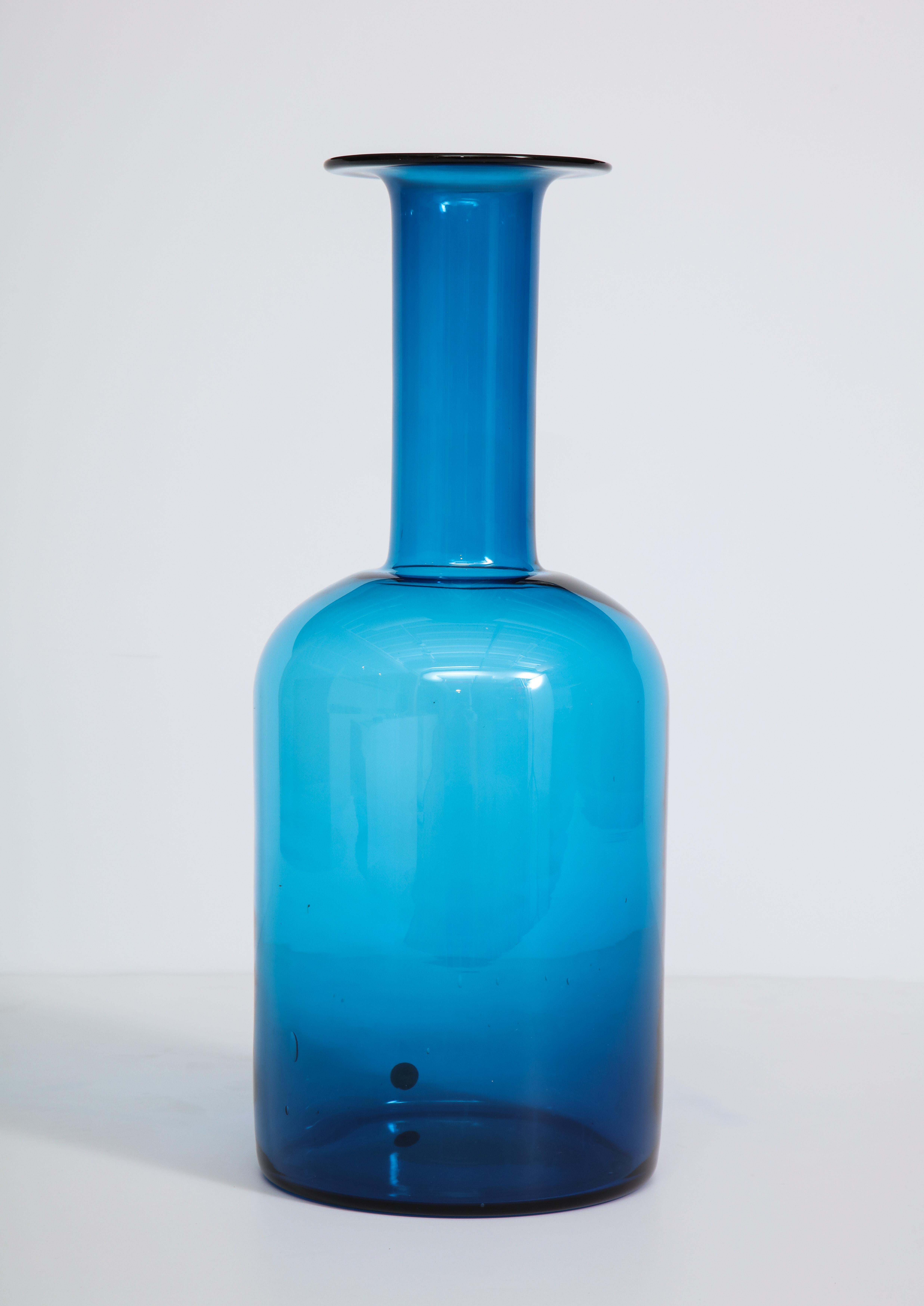 Decorative tall, blue glass bottle by Holmegaard, Denmark, circa 1960. The item is in a very good condition.