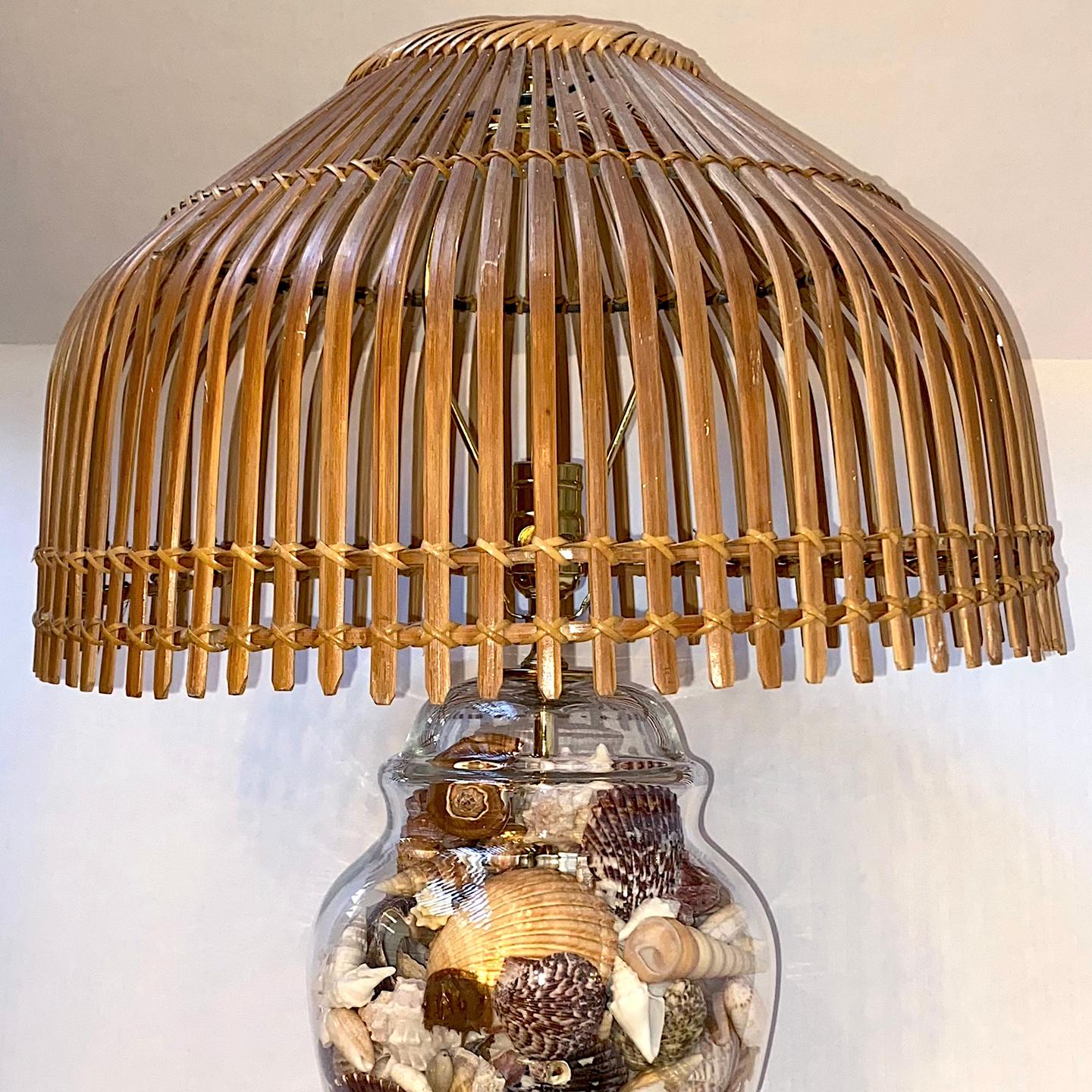 A circa 1960's American glass lamp with shells and bamboo shade.

Measurements:
Shade Diameter: 18.5
