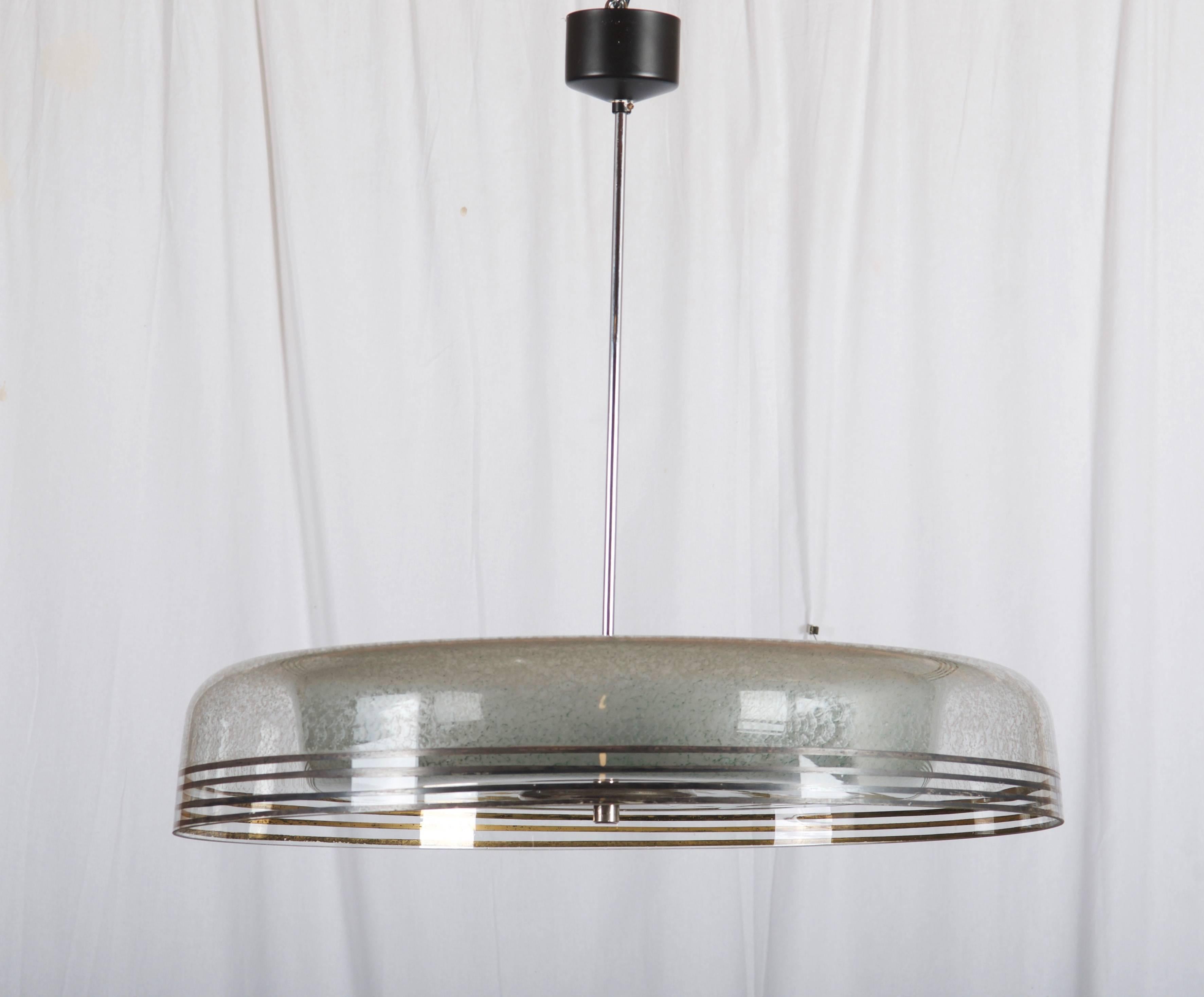 Elegant glass shade on a steel hanger fitted with three E27 sockets up to 60watts each.
Total length can be customized.
Made by Napako in the late 1950s.