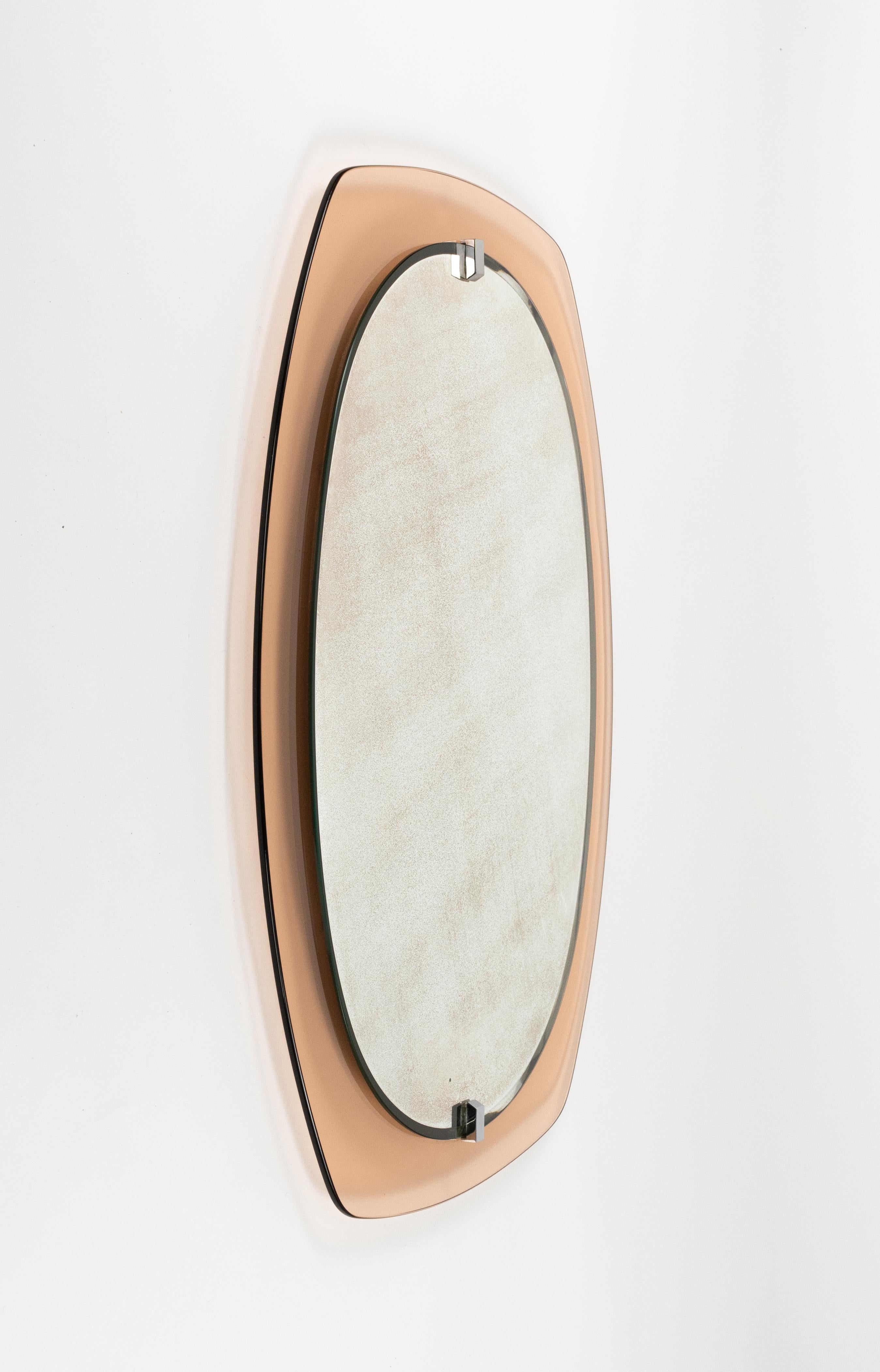 Midcentury beautiful wall mirror framed by old pink glass by Veca. 

Made in Italy in the 1970s.

The mirror would be perfect for a bedroom, dressing room, cloakroom or hallway.

The mirror, original of the period, shows signs of discolouration.