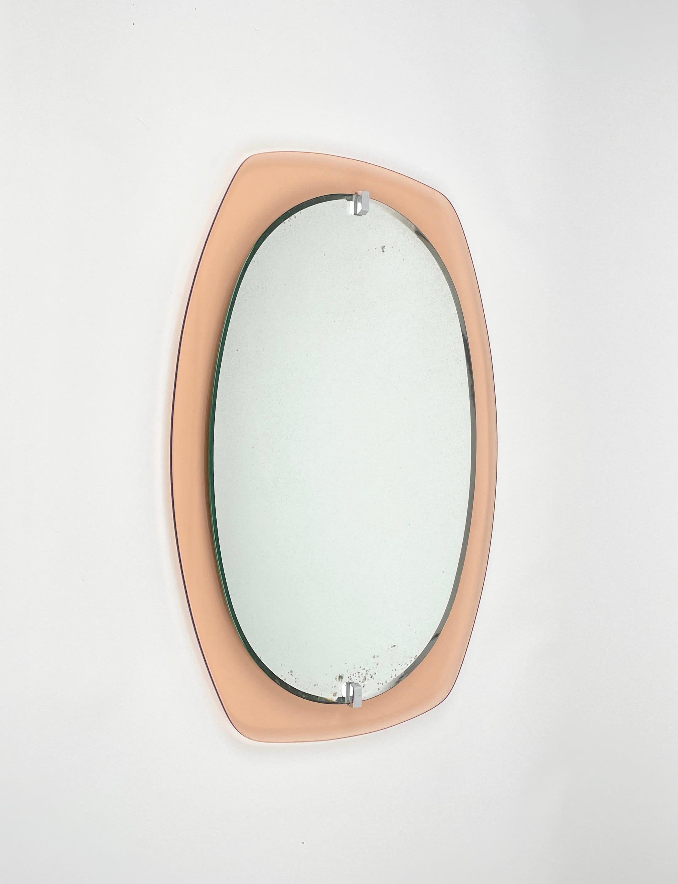 Wall mirror framed by old pink glass by Veca. 

Made in Italy in the 1970s.