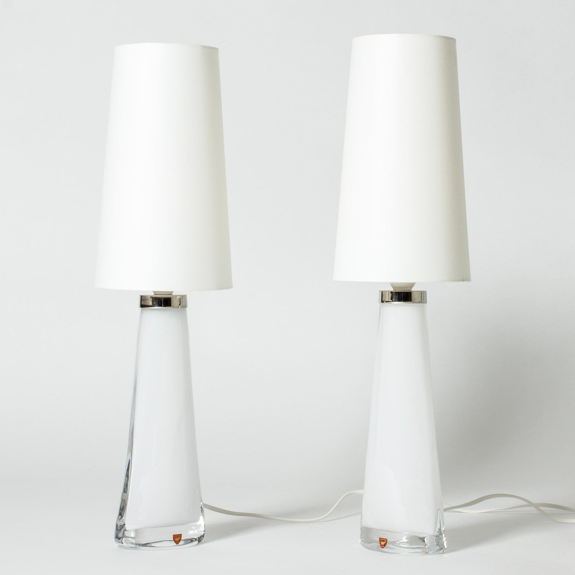 Pair of crystal glass table lamps by Carl Fagerlund, made from white glass in a narrow conical shape, almond shaped at the base. Beautiful translucent color, elegant design.