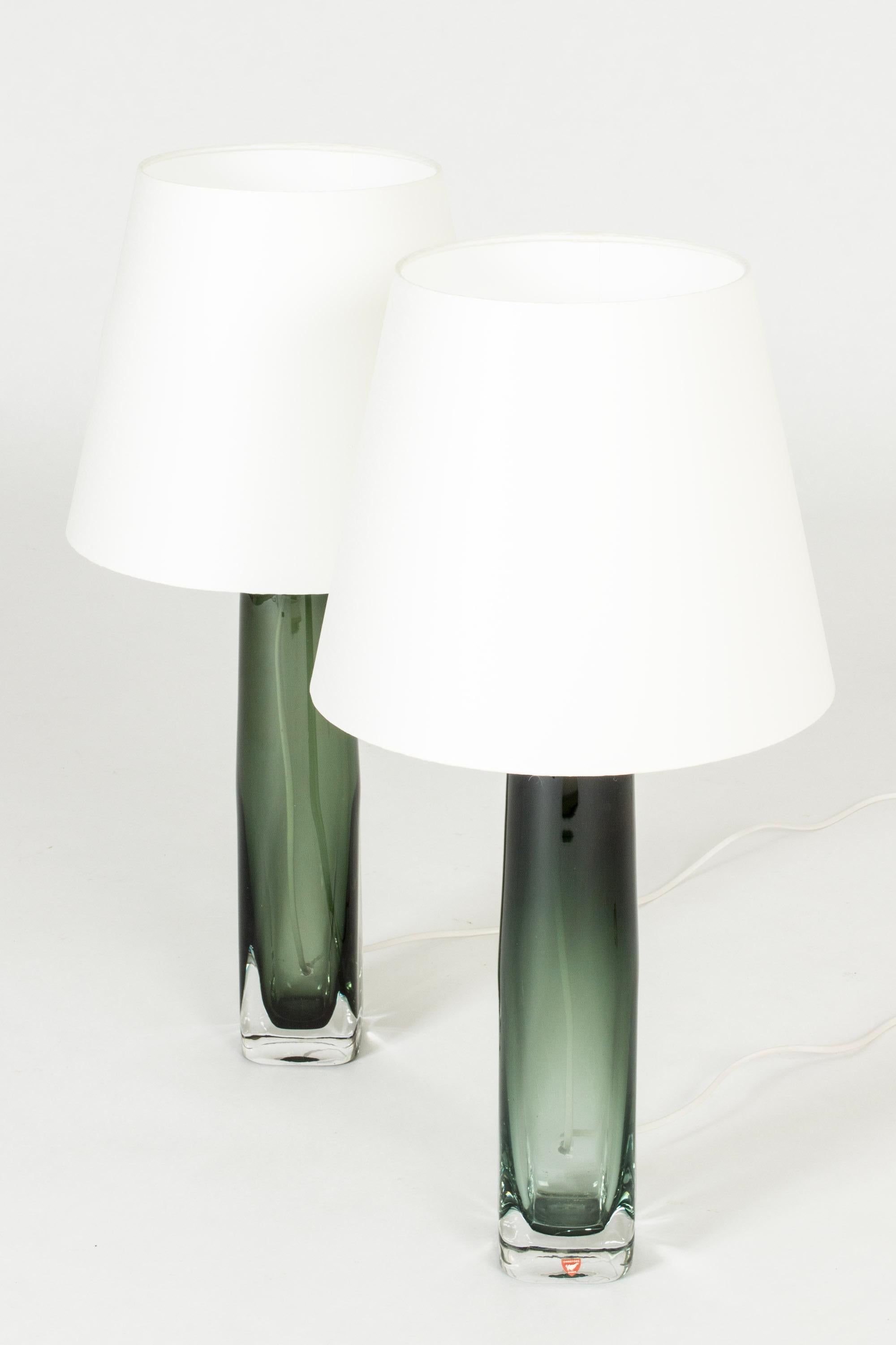 Pair of crystal glass table lamps by Carl Fagerlund, made from dark brown colored glass in a narrow conical shape, almond shaped at the base. Beautiful translucent color, elegant design.