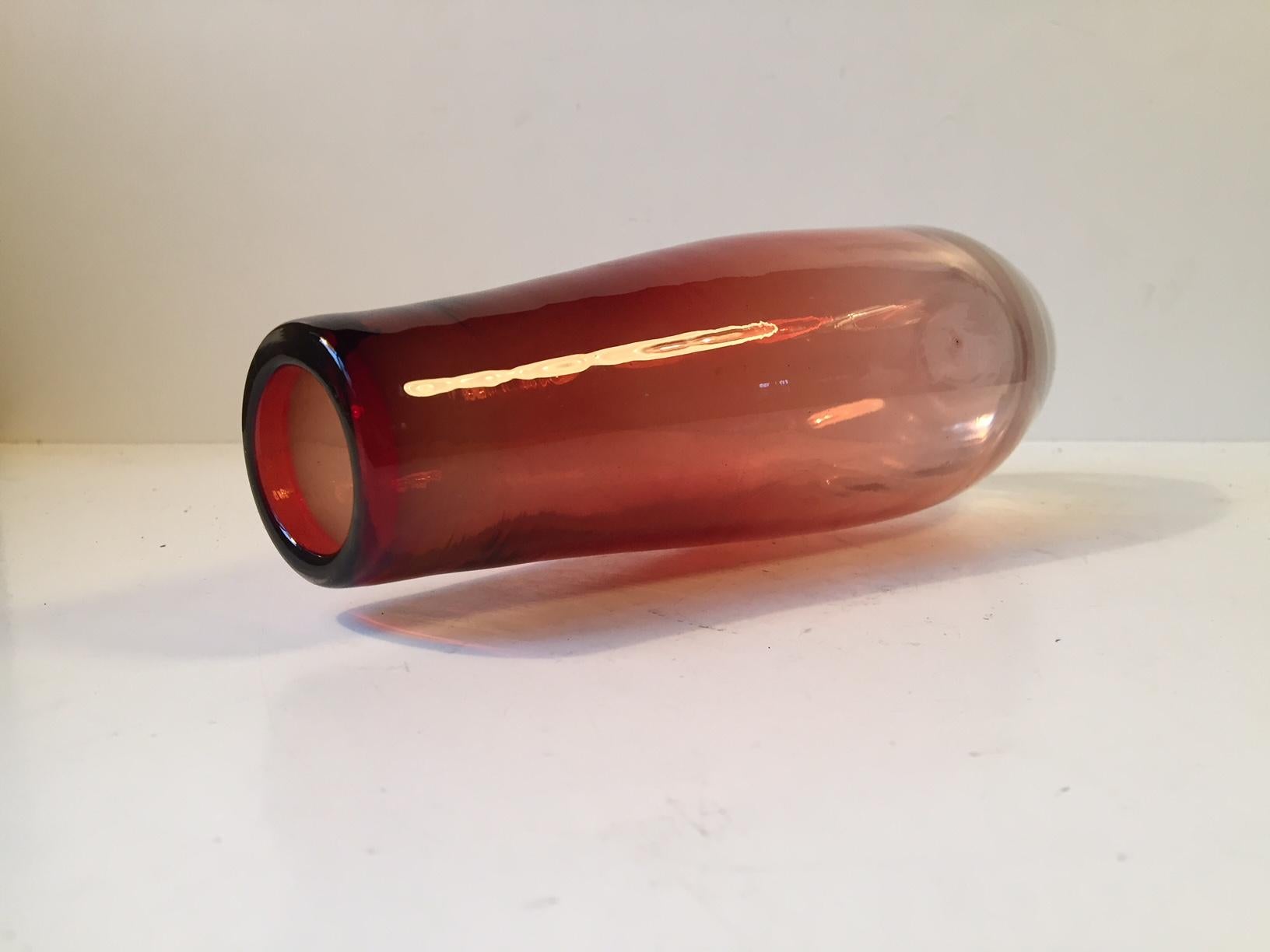 This red and clear glass vase was designed by Nils Landberg in the mid-1950s and manufactured by Orrefors in Sweden. Due to wear, the signature on the base is very faint.