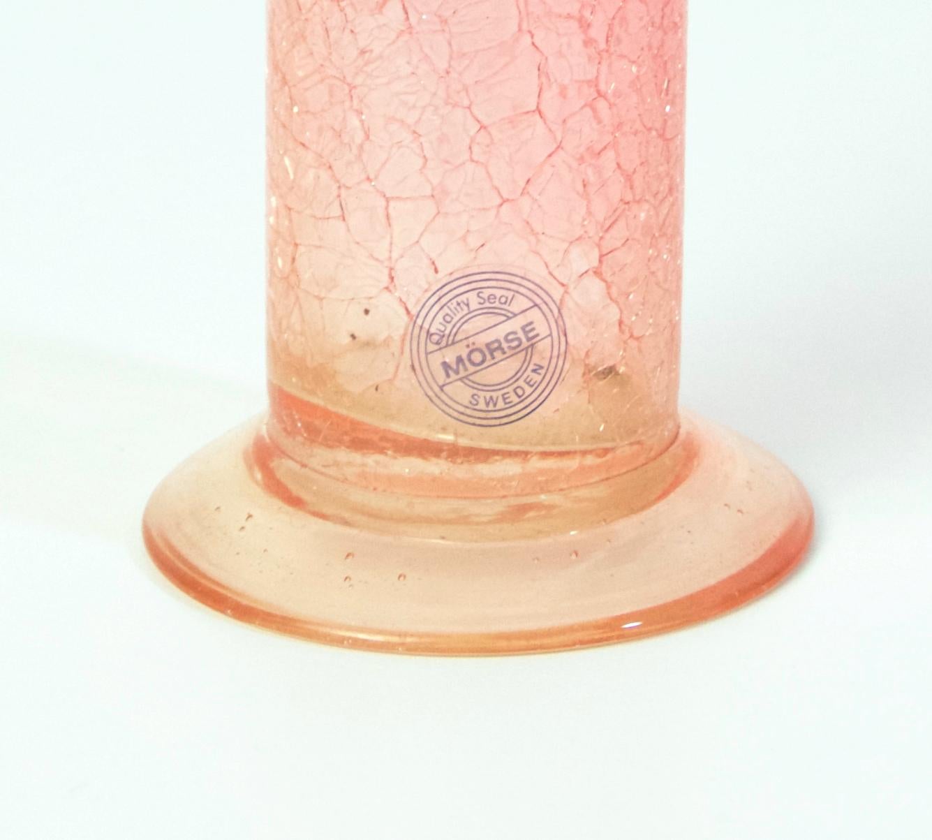 Swedish tall cylinder shaped vase in pink glass with an intentional crackled design from the 1970s. Marked with a sticker from the retailer MÖRSE.
 