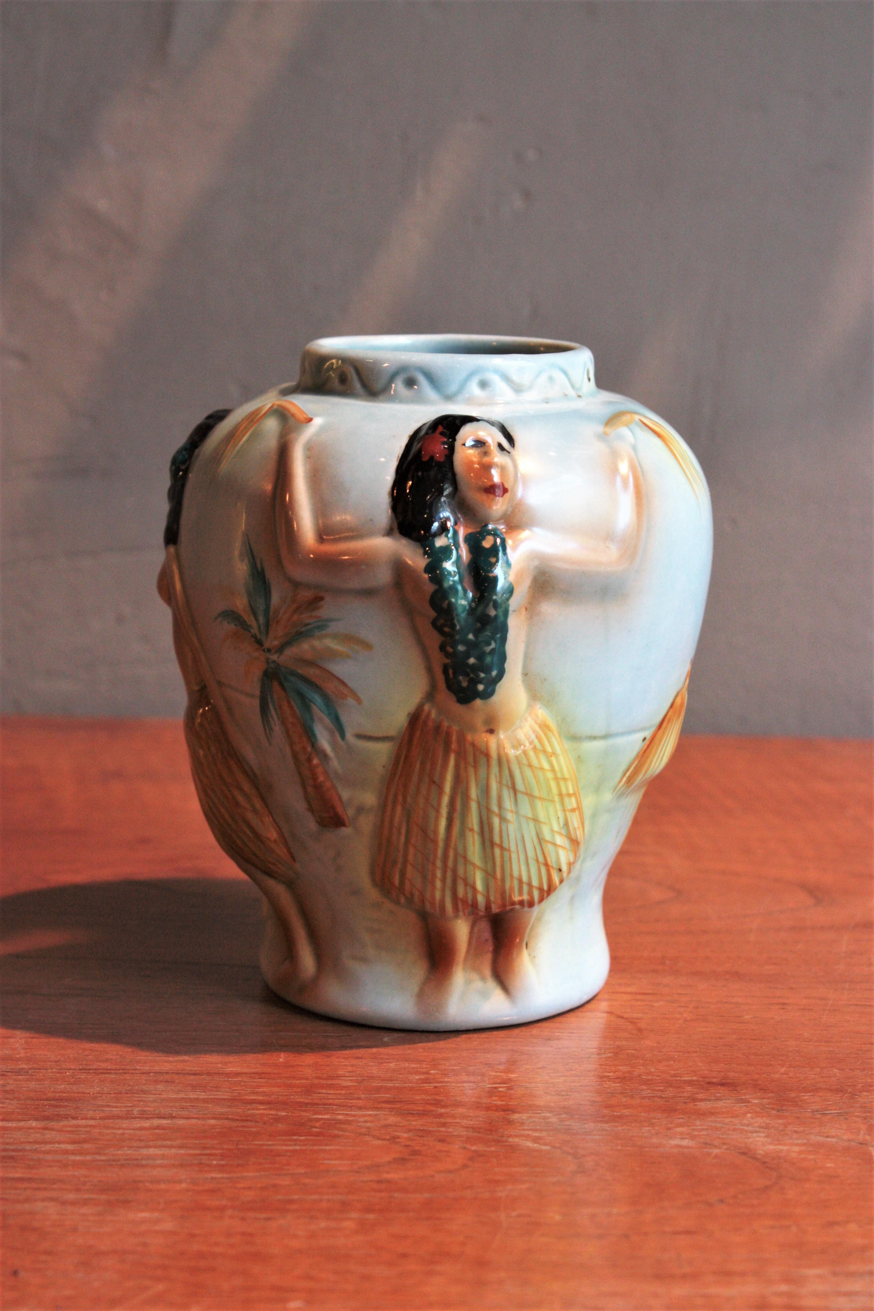 Colorful Midcentury Ceramic Urn vase, Spain, 1950s-1960s.
Beautiful small blue glazed ceramic vase featuring hand-painted hawaian Hula dancers.
Eye-catching from all sides.
It will be a nice addition to any ceramics collection. Perfect as a gift