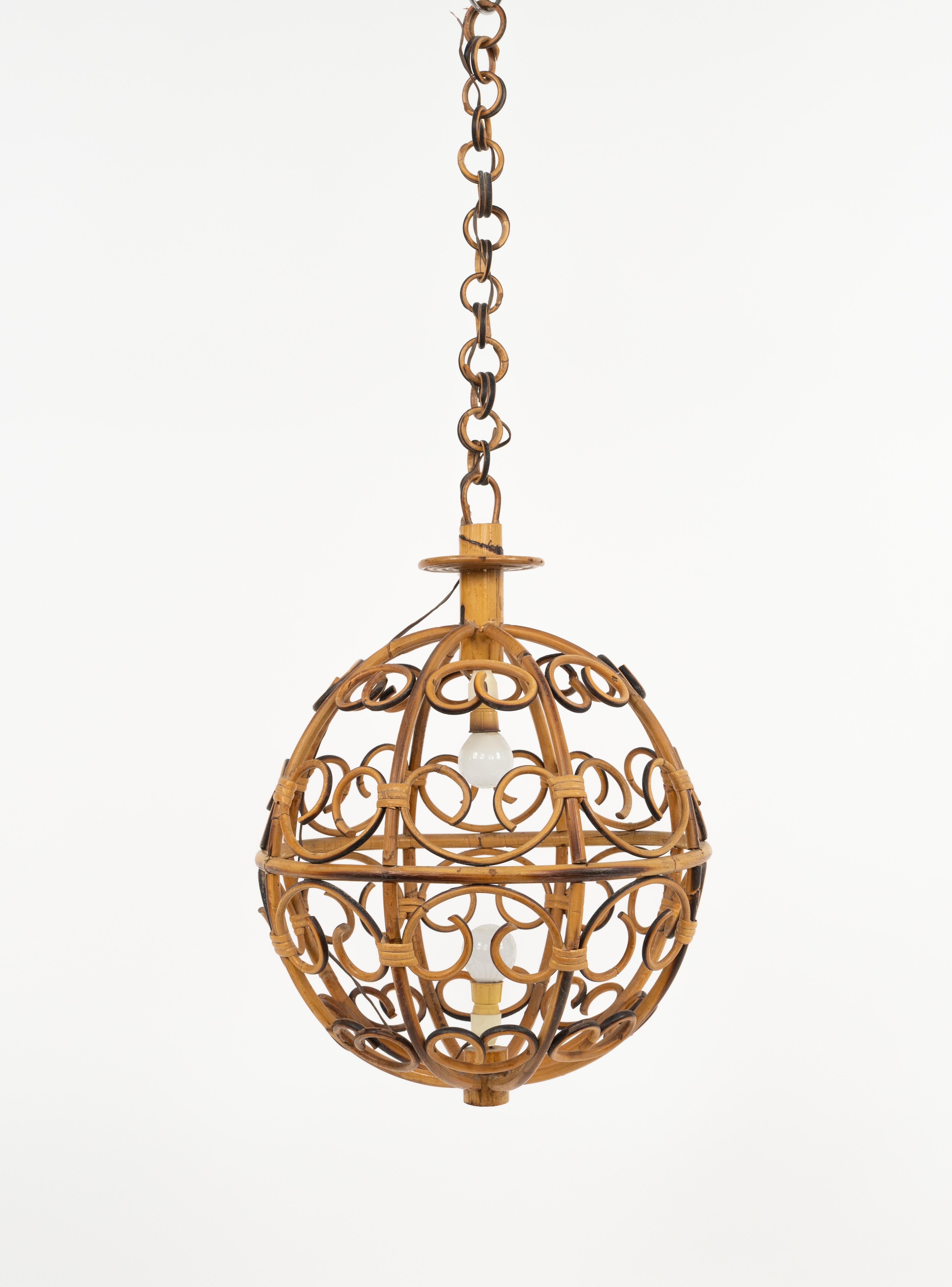 Midcentury beautiful chandelier ball shaped.

Made in Italy in the 1960s.

This suspension lamp is entirely handcrafted with rattan and bamboo. 

The ball shaped shade hangs from a chain with round rattan links which can be shortened to adjust it to