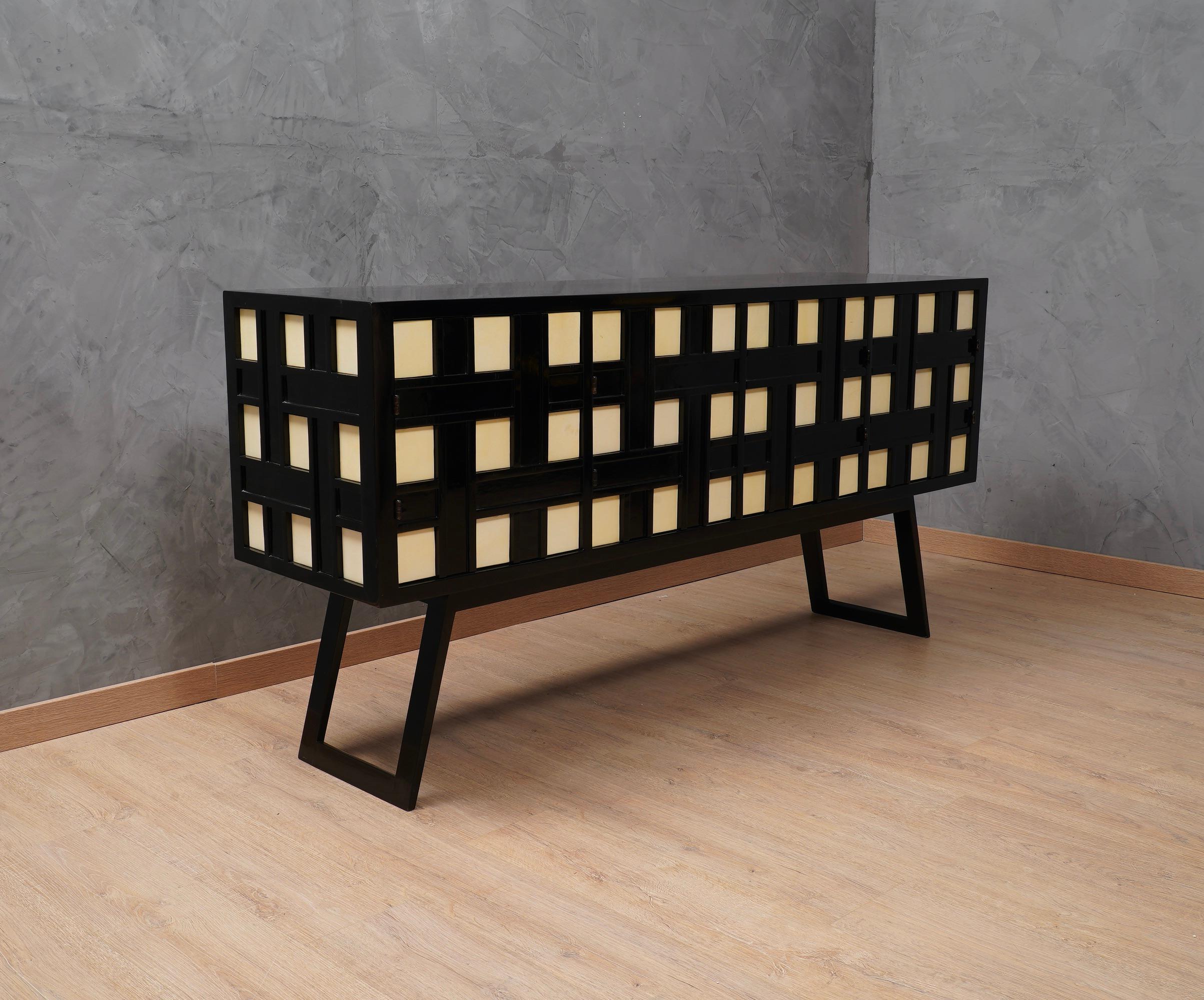 Unique and very original design for a one-of-a-kind sideboard, rich but linear, an intertwining of sure Italian taste.

The sideboard is in black shellac lacquered wood, well polished and finished. The Italian design derives from this intertwining