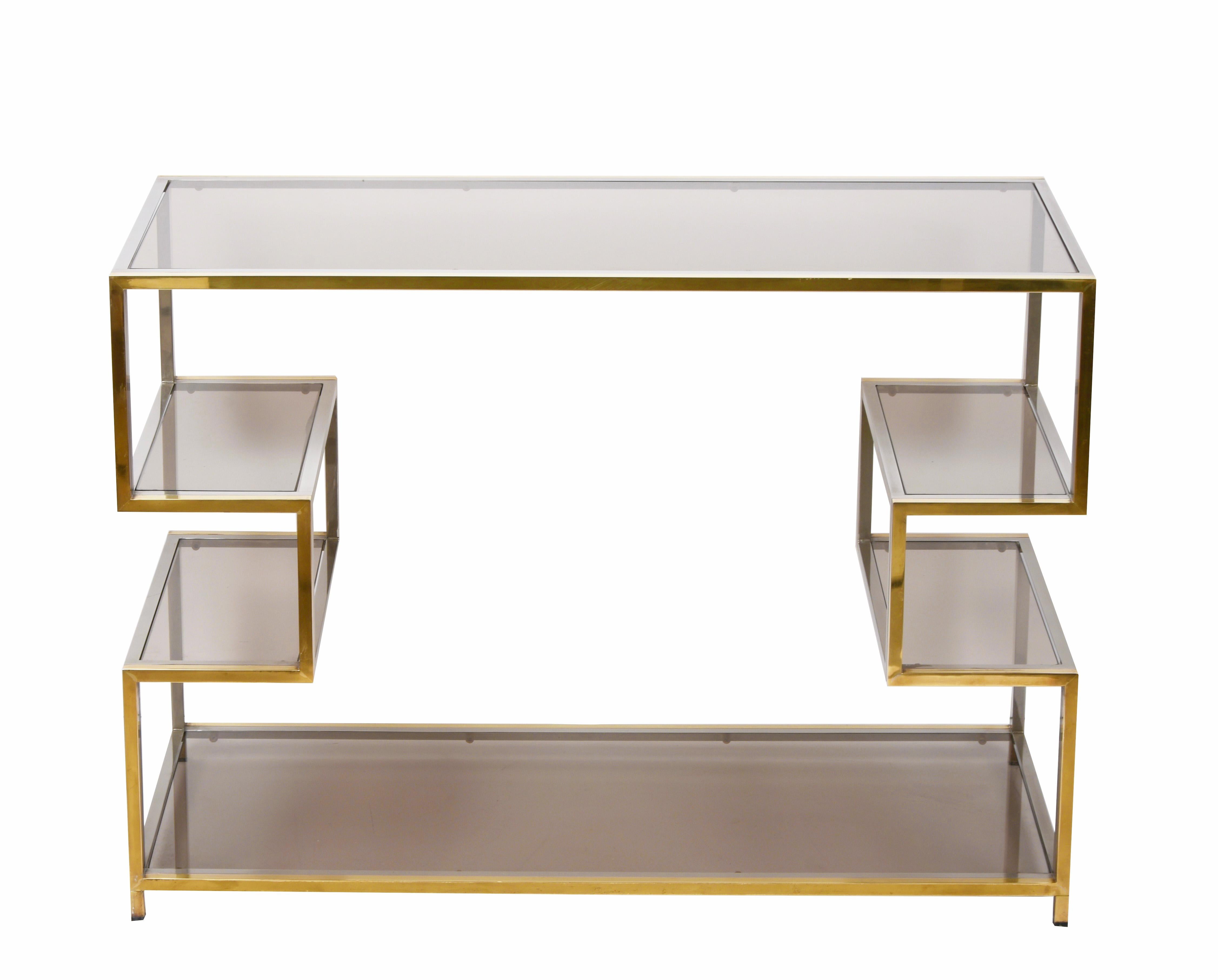 Amazing mid-century gold brass and glass console table. This marvellous piece was designed in Italy during the 1970s.

This fantastic piece is in golden brass, chromed metal and smoked glasses, with straight lines on the top and bottom shelves and